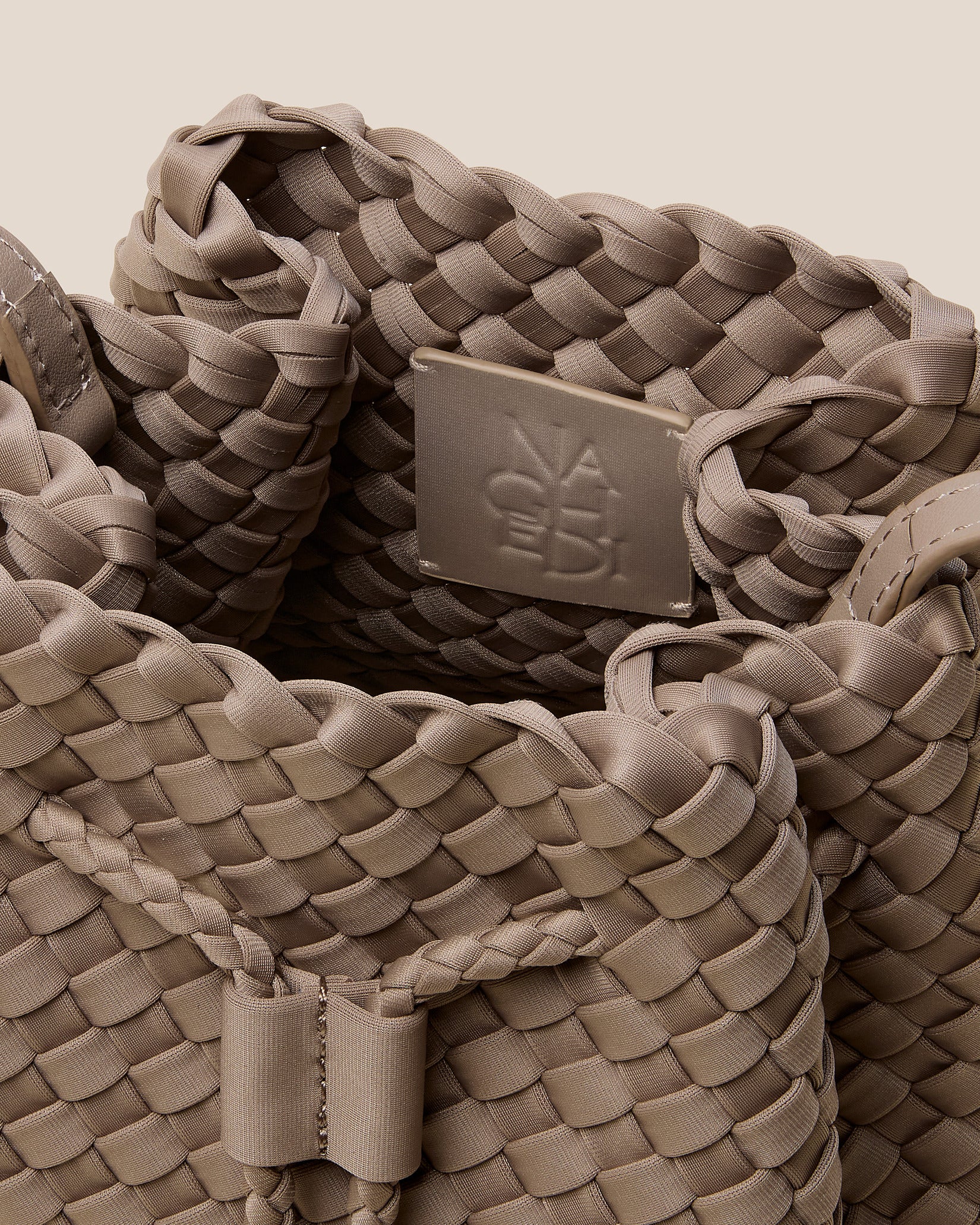 Interior close-up of Gramercy Medium Bucket Bag in Cashmere showing its drawstring closure, and unlined interior.
