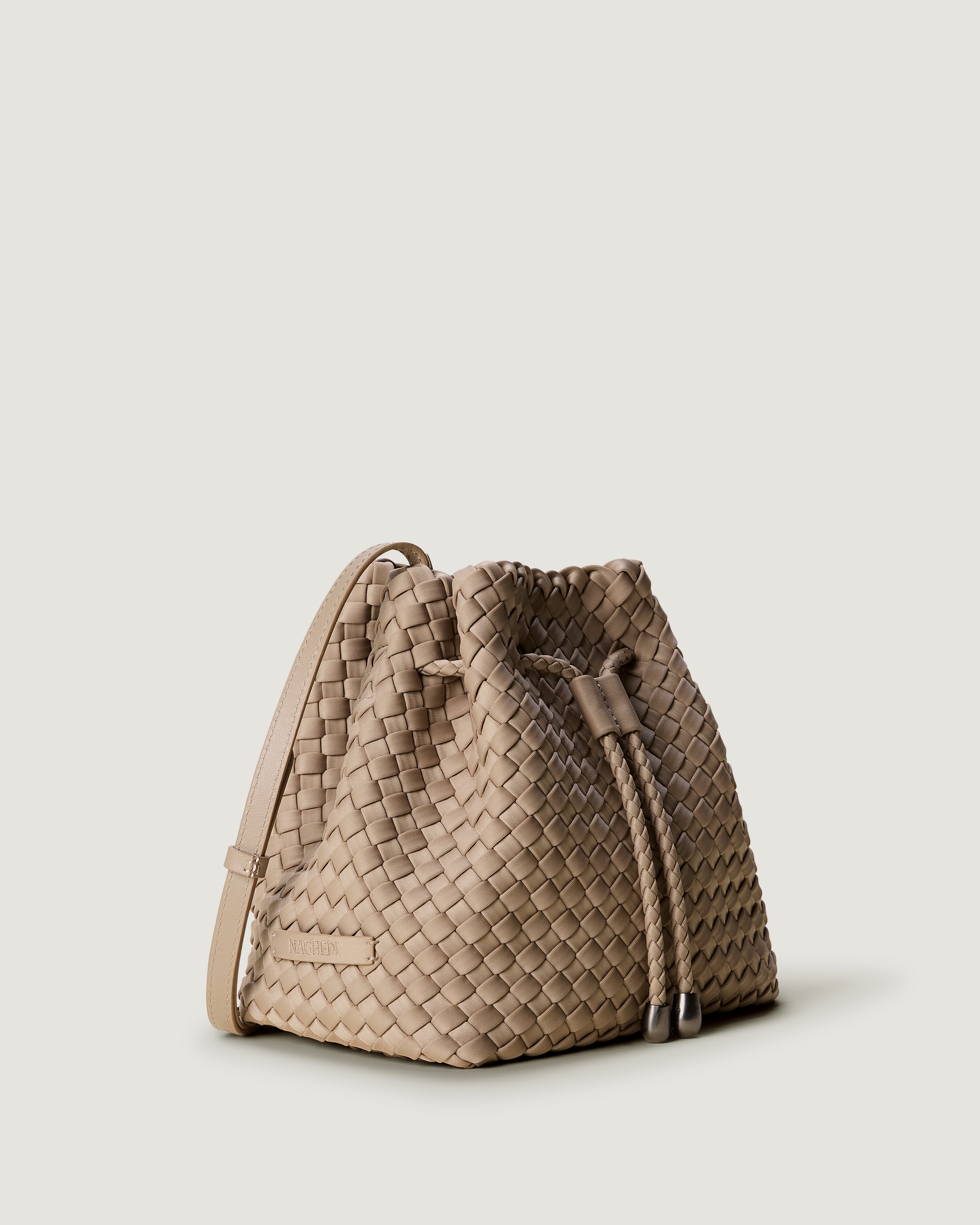 Gramercy Bucket in Cashmere shown from a side angle, highlighting its handwoven neoprene construction and drawstring closure.
