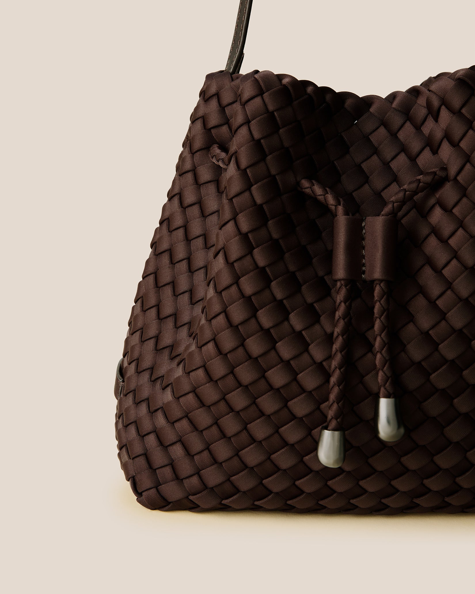 Close-up of handwoven detailing on Gramercy Medium Bucket Bag in Chocolate.