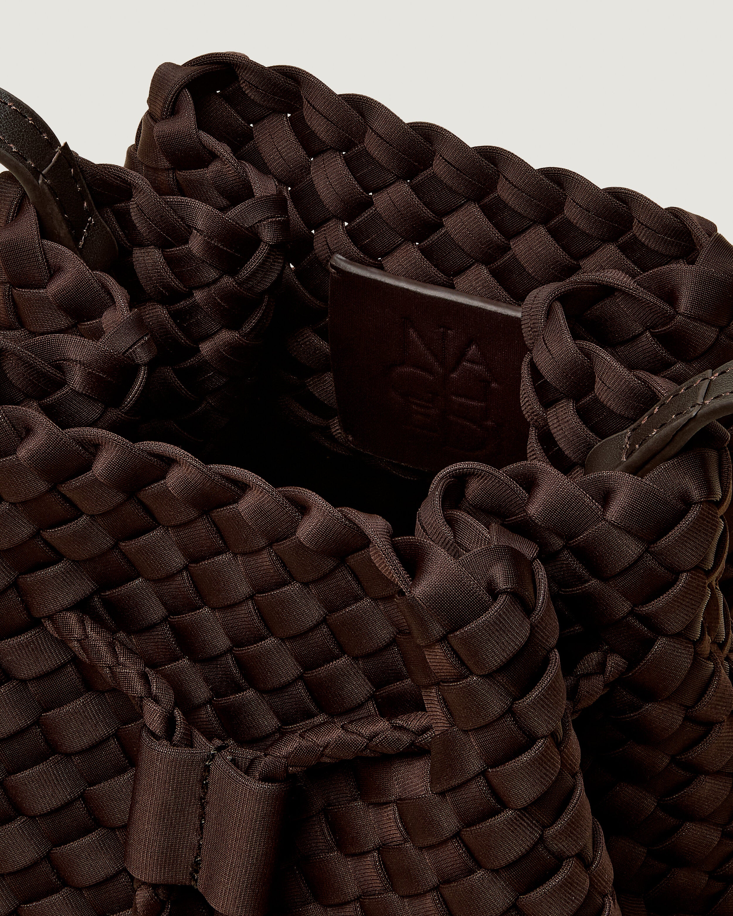 Interior close-up of Gramercy Bucket in Chocolate showing its drawstring closure, and unlined interior.