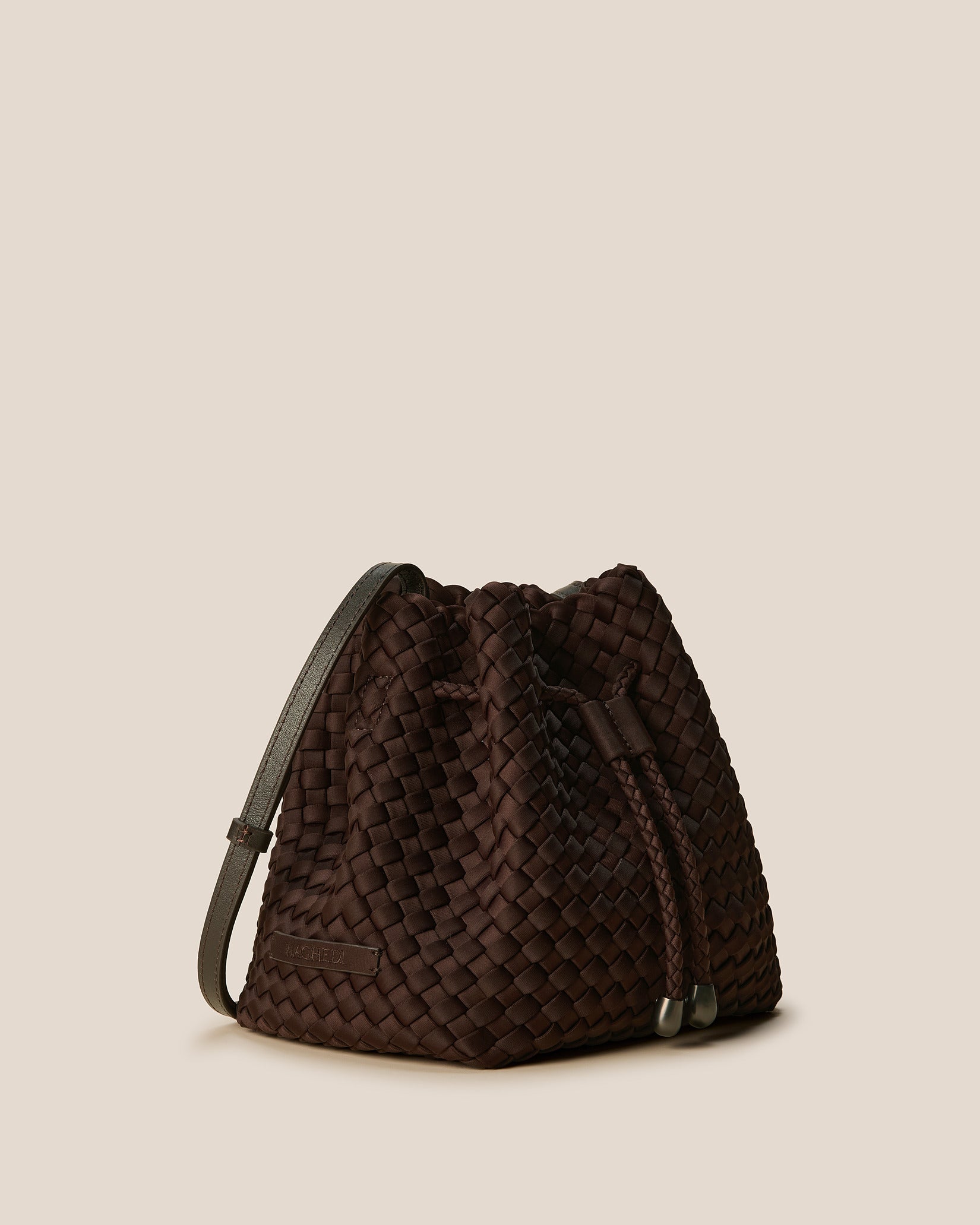 Gramercy Medium Bucket Bag in Chocolate shown from a side angle, highlighting its handwoven neoprene and drawstring closure.
