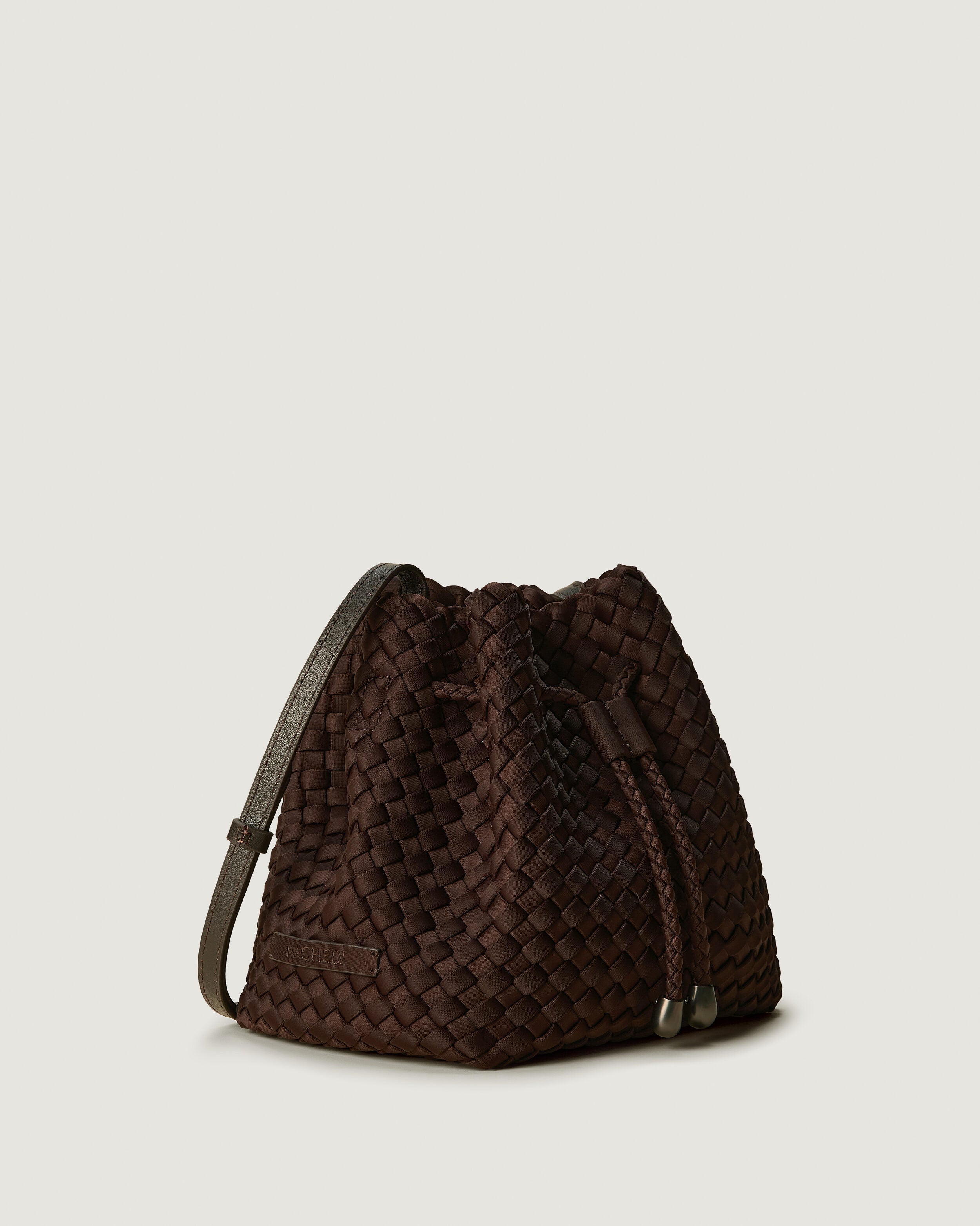 Gramercy Bucket in Chocolate shown from a side angle, highlighting its handwoven neoprene construction and drawstring closure.