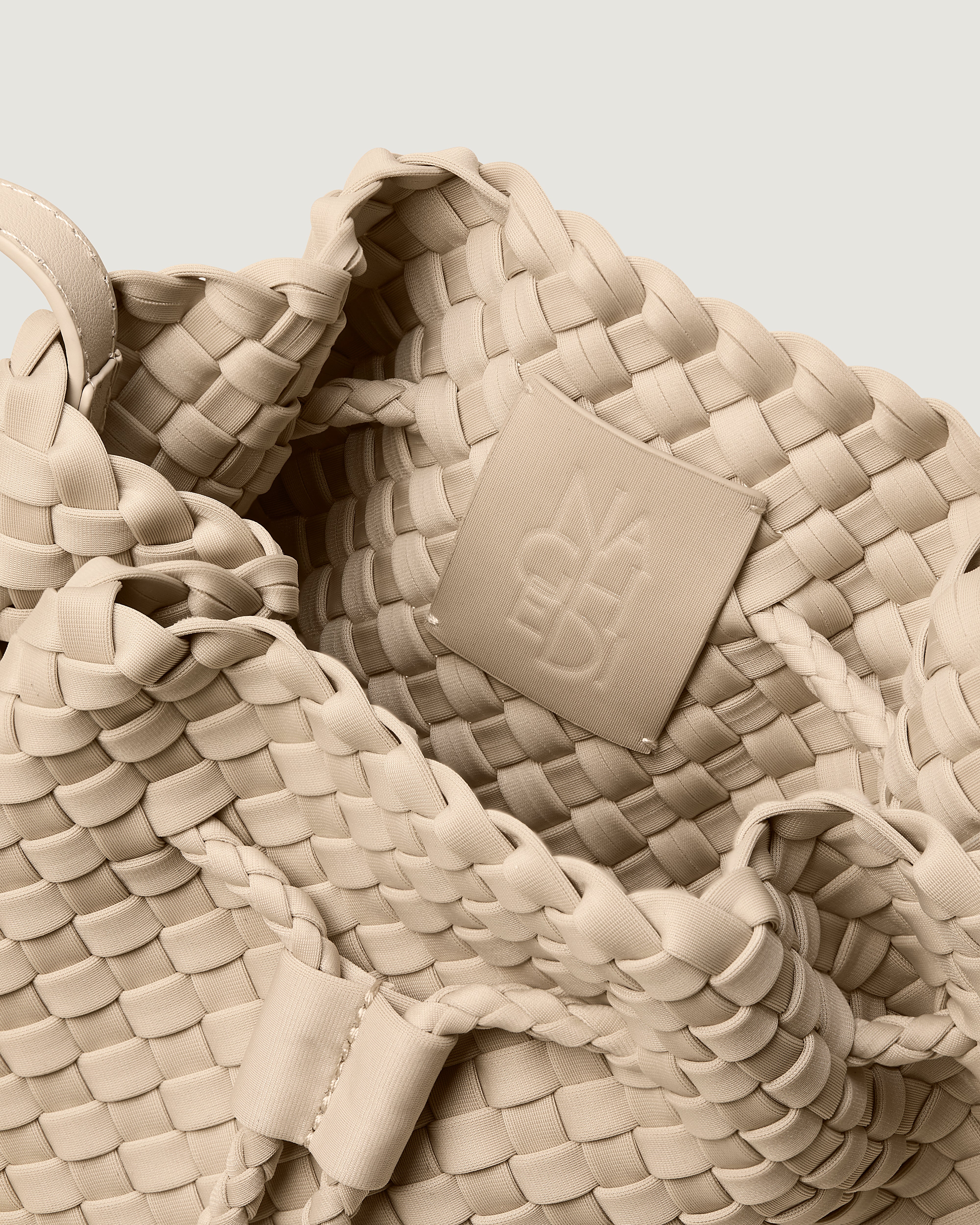 Interior close-up of Gramercy Bucket in Ecru showing its drawstring closure, and unlined interior.