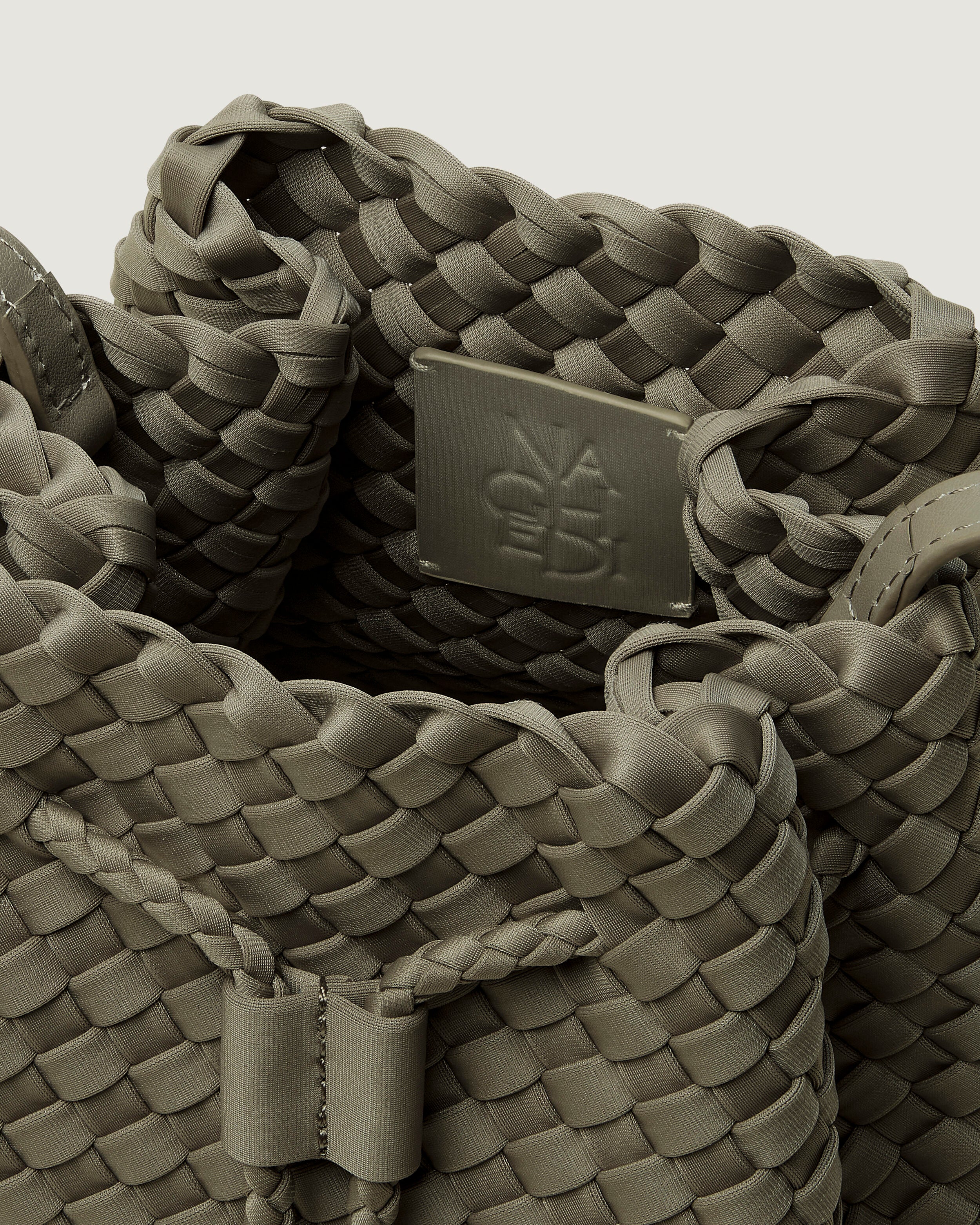 Interior close-up of Gramercy Bucket in Olea showing its drawstring closure, and unlined interior.