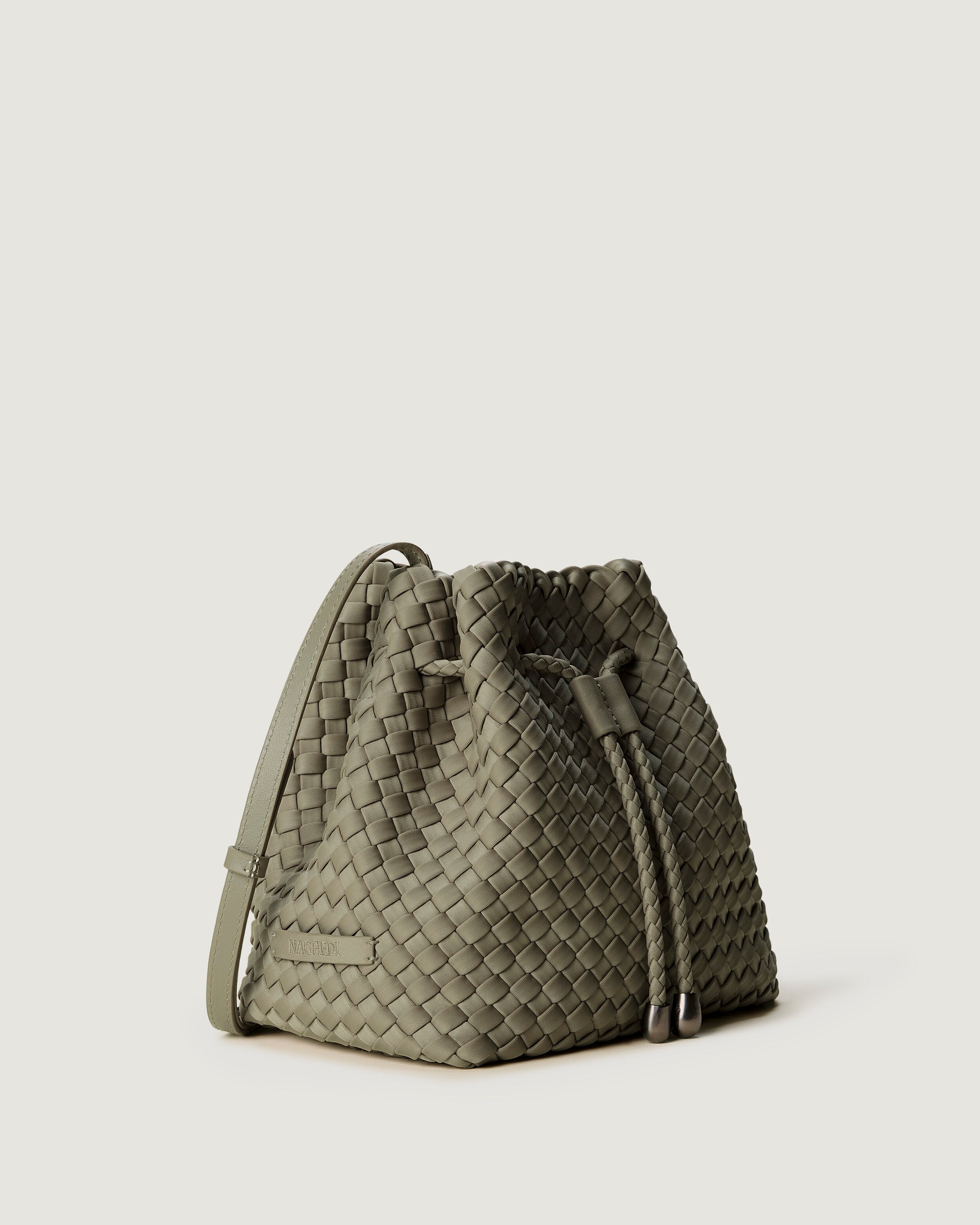 Gramercy Bucket in Olea shown from a side angle, highlighting its handwoven neoprene construction and drawstring closure.