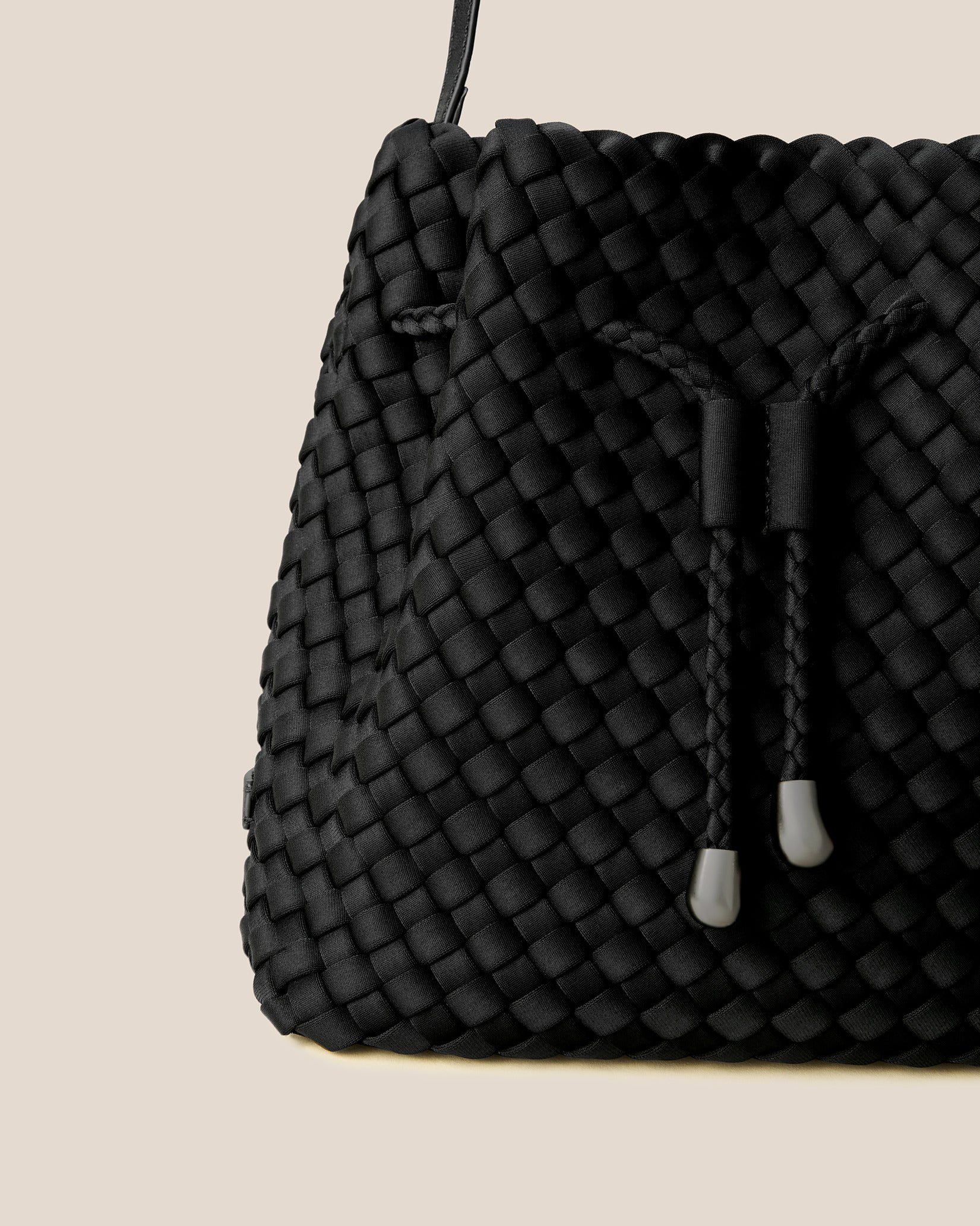 Close-up of handwoven detailing on Gramercy Medium Bucket Bag in Onyx.