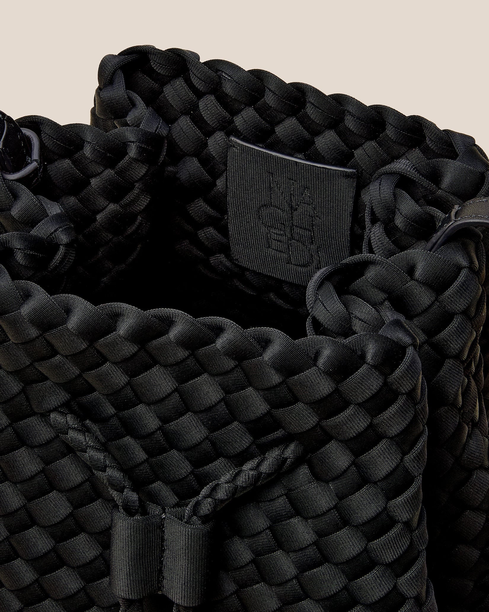 Interior close-up of Gramercy Medium Bucket Bag in Onyx showing its drawstring closure, and unlined interior.