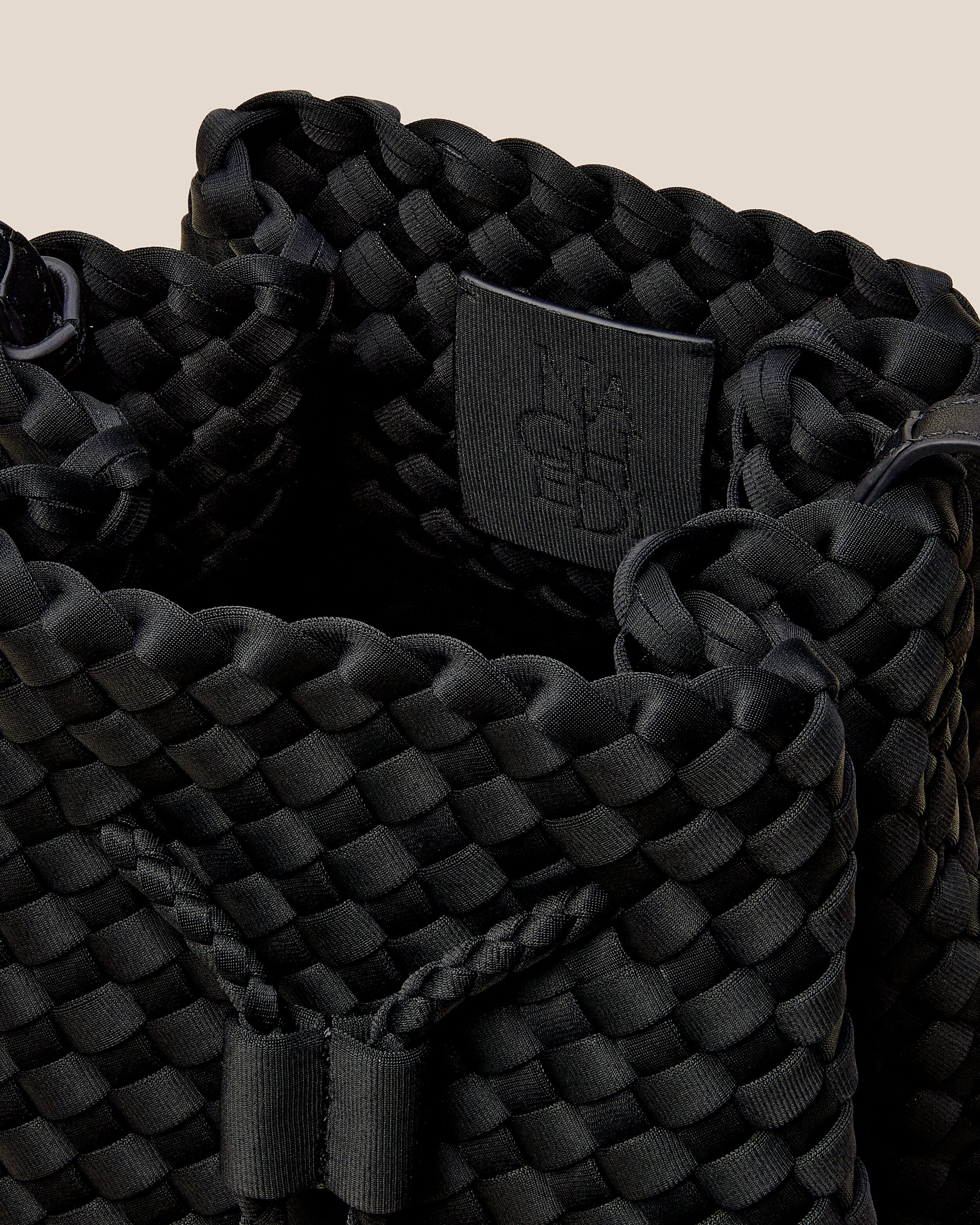 Interior close-up of Gramercy Bucket in Onyx showing its drawstring closure, and unlined interior.