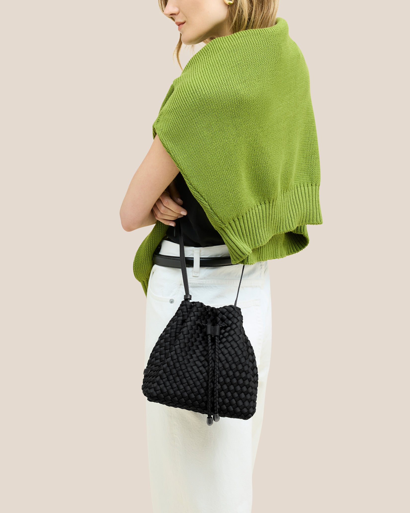 Gramercy Medium Bucket Bag in Onyx shown on model to illustrate scale and soft silhouette.
