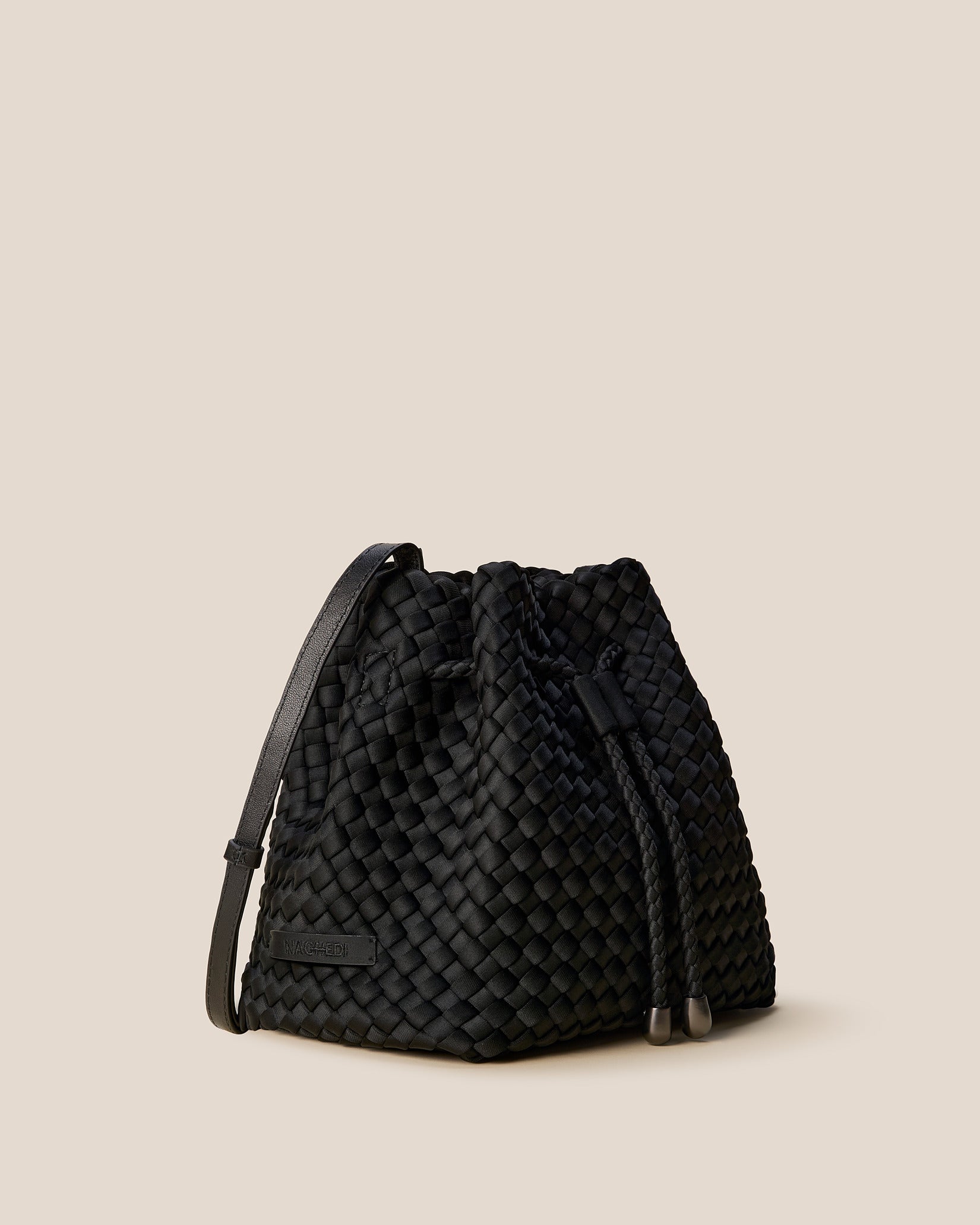 Gramercy Medium Bucket Bag in Onyx shown from a side angle, highlighting its handwoven neoprene and drawstring closure.