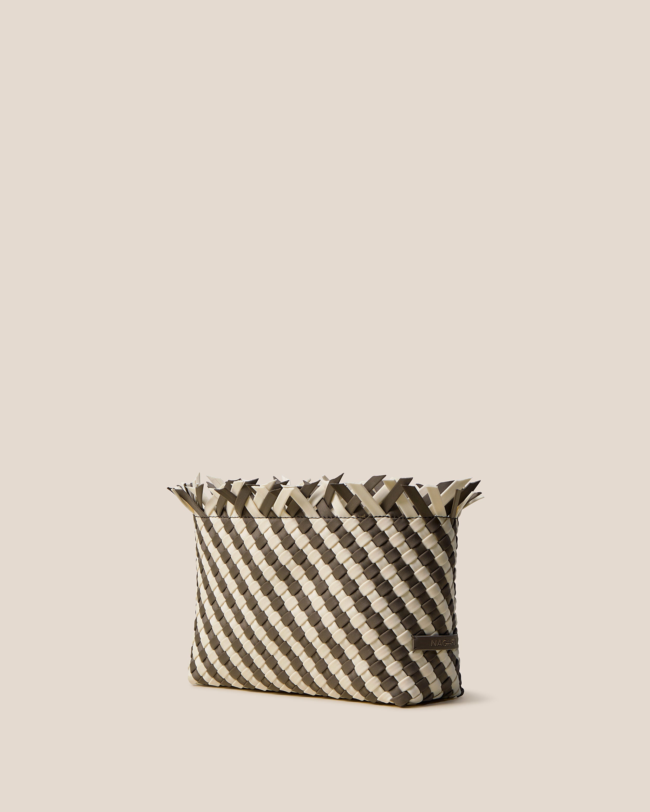 Havana  in Carrara shown from a side angle, highlighting its handwoven neoprene construction and magnetic snap closure.