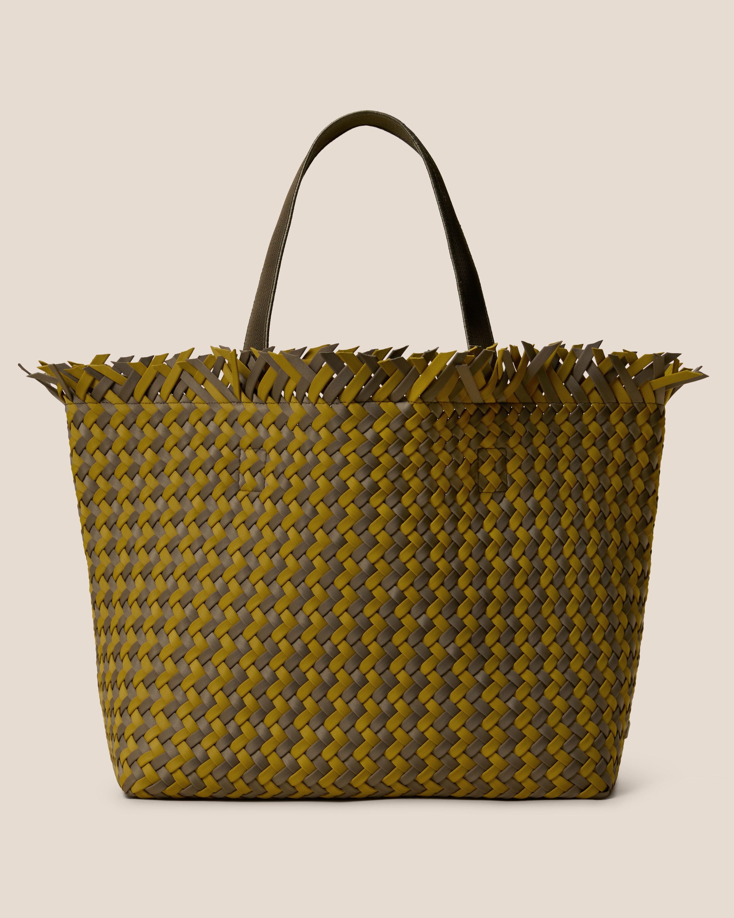 Havana  in Palma, a yellow-green and muted earh brown tone, in handwoven neoprene, featuring an open top with magnetic snap closure, and sleek nylon webbing handles fit over the shoulder.