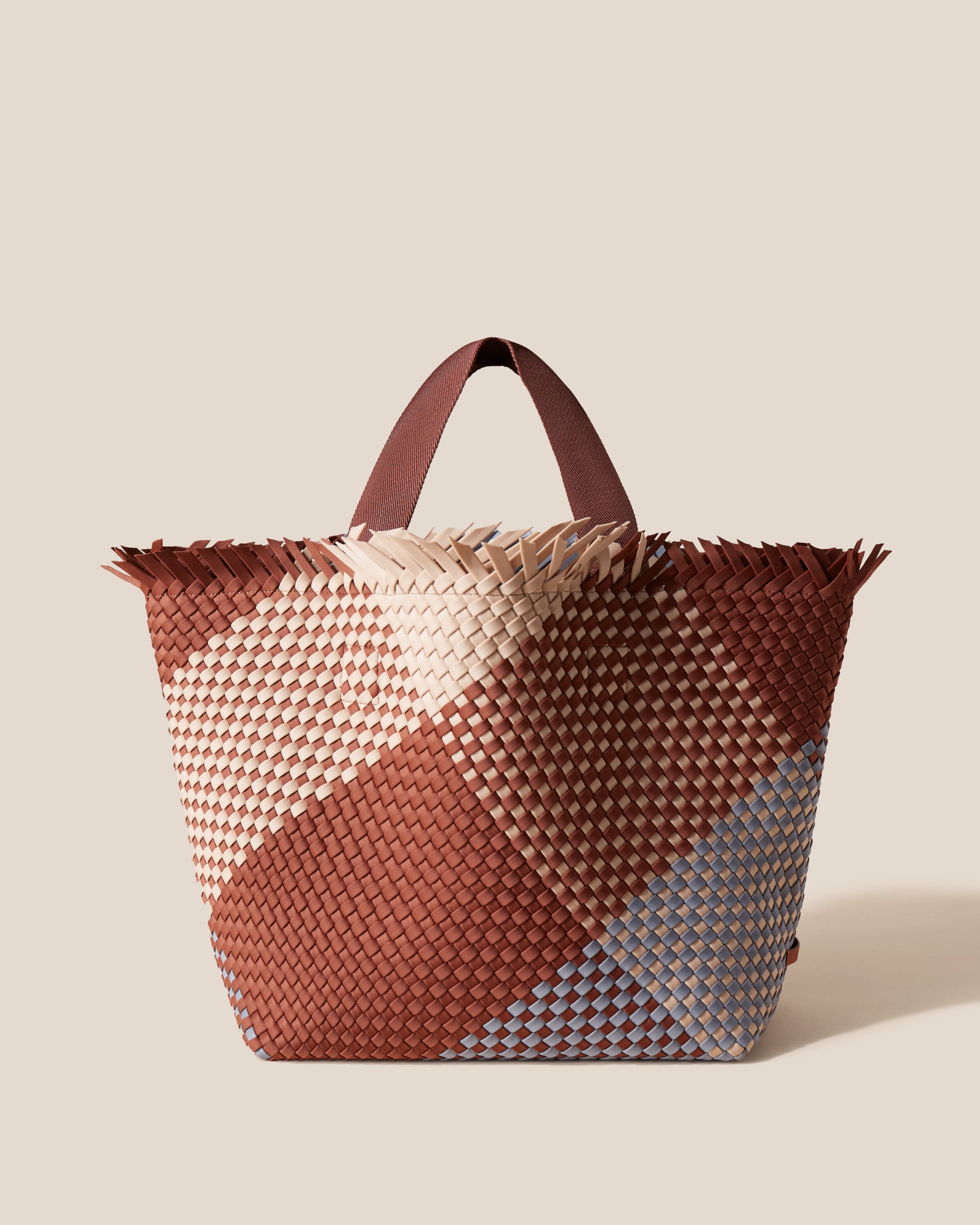 Havana  in Taos, a clay brown, nude and gray tone, in handwoven neoprene, featuring an open top with magnetic snap closure, and sleek nylon webbing handles fit over the shoulder.