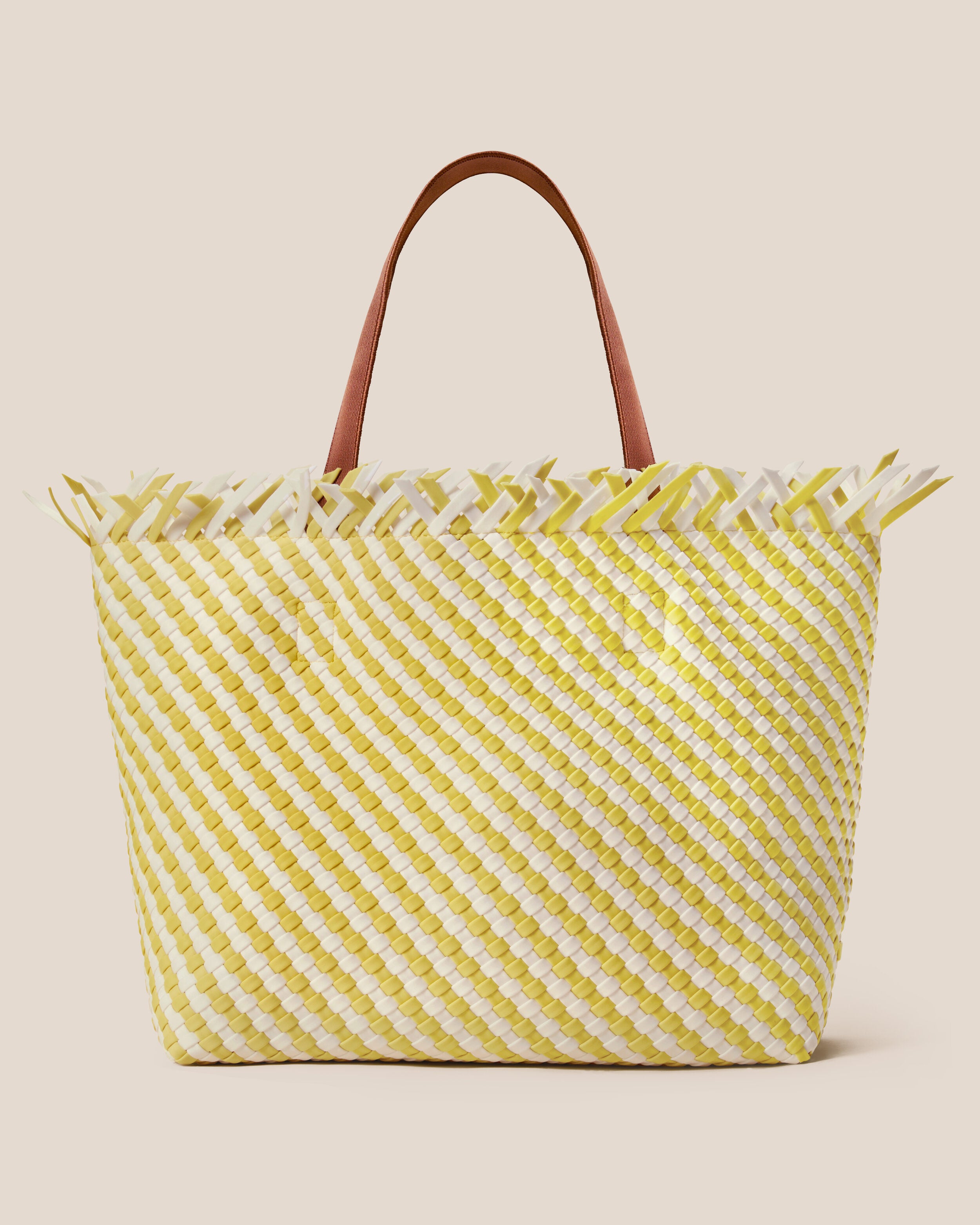 Havana  in Soleil, a white and yellow tone, in handwoven neoprene, featuring an open top with magnetic snap closure, and sleek nylon webbing handles fit over the shoulder.