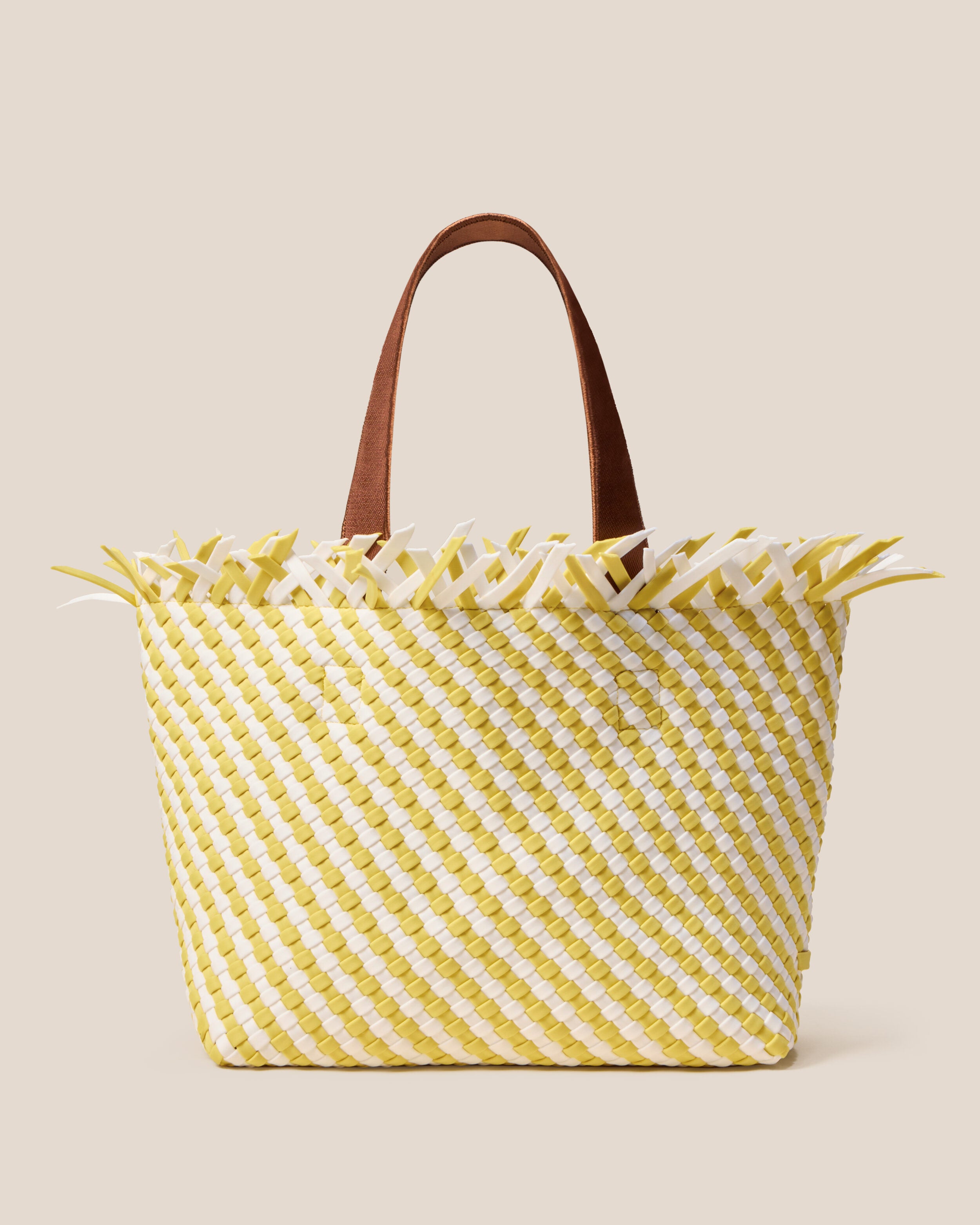 Havana  in Soleil, a white and yellow tone, in handwoven neoprene, featuring an open top with magnetic snap closure, and sleek nylon webbing handles fit over the shoulder.