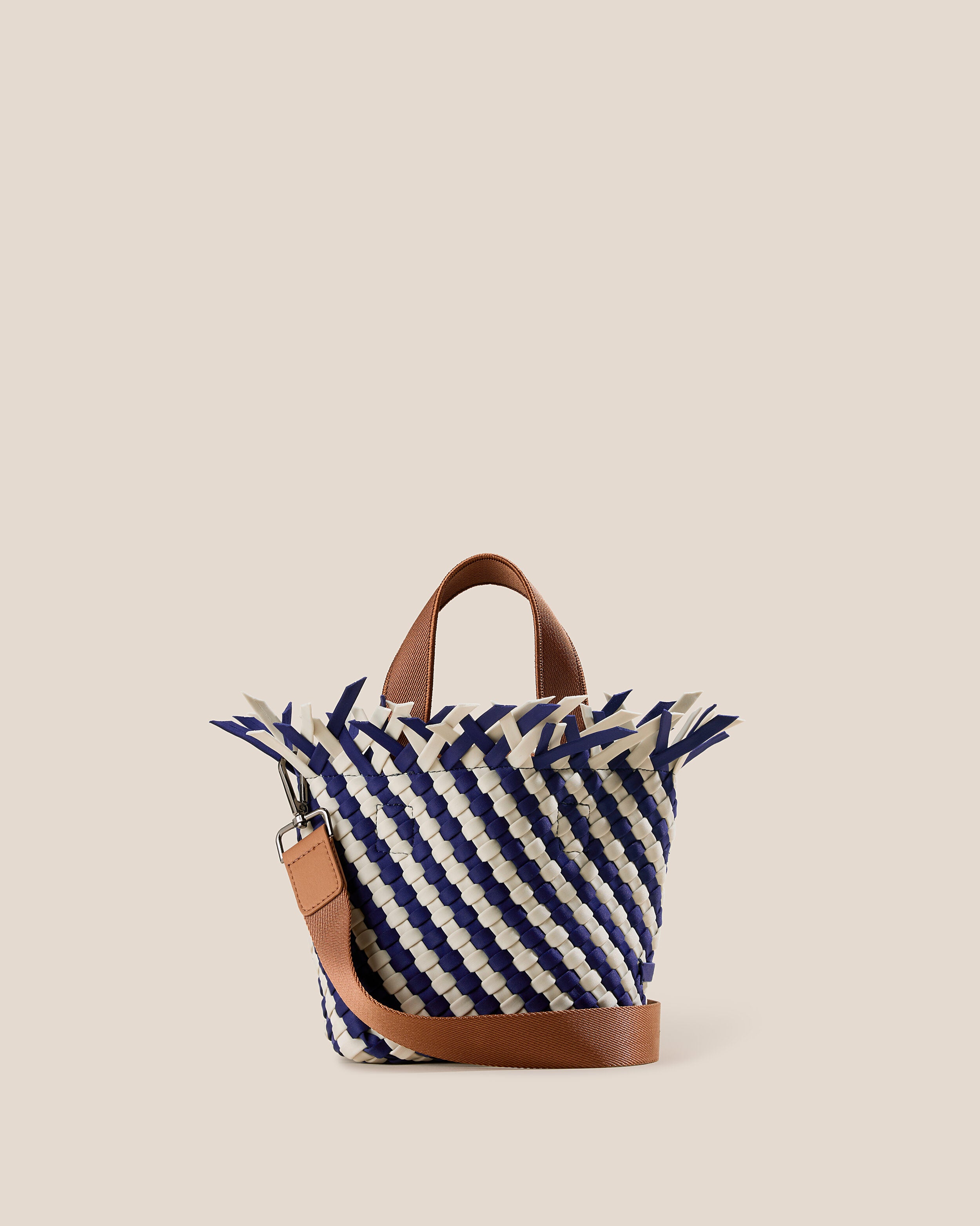Havana  in Venice, a navy blue and dove white tone, in handwoven neoprene, featuring an open top with magnetic snap closure, sleek nylon webbing handles, and detachable, adjustable nylon crossbody strap.