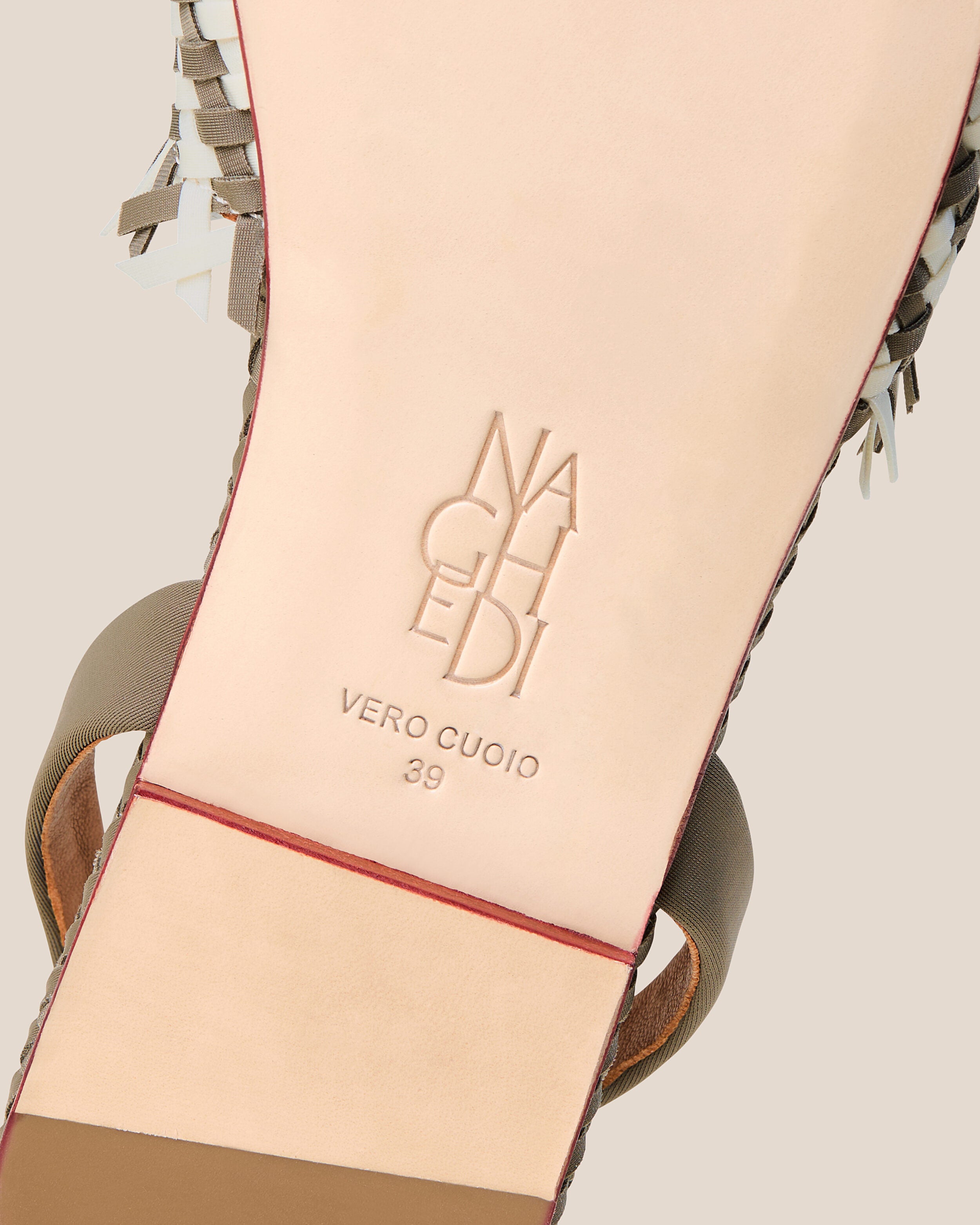 Shoe sole showing natural buffed leather sole, stamped NAGHEDI logo and size detail for The Havana Sandal in Carrara.