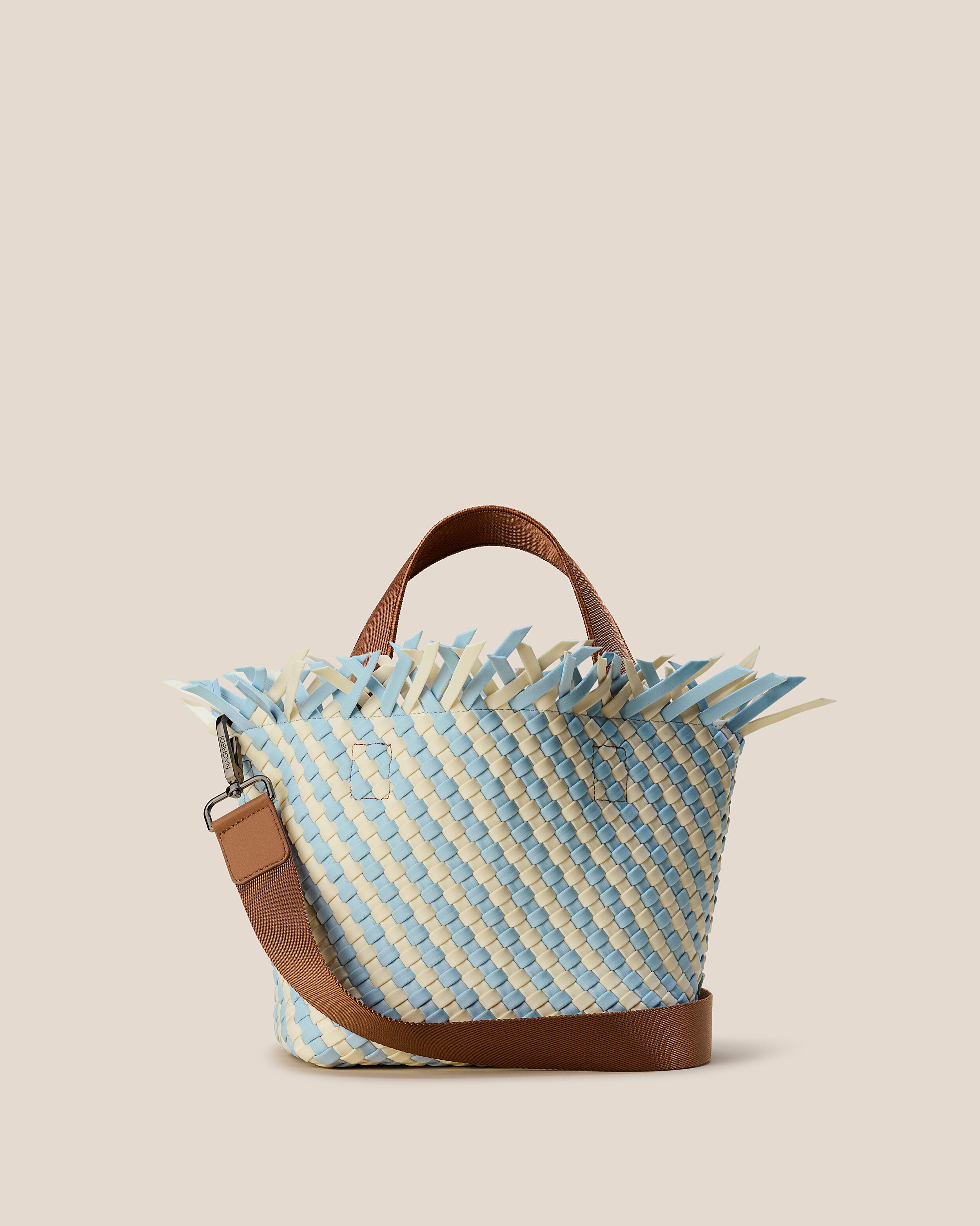 Havana  in Sky, a pale blue and bone tone, in handwoven neoprene, featuring an open top with magnetic snap closure, sleek nylon webbing handles, and detachable, adjustable nylon crossbody strap.