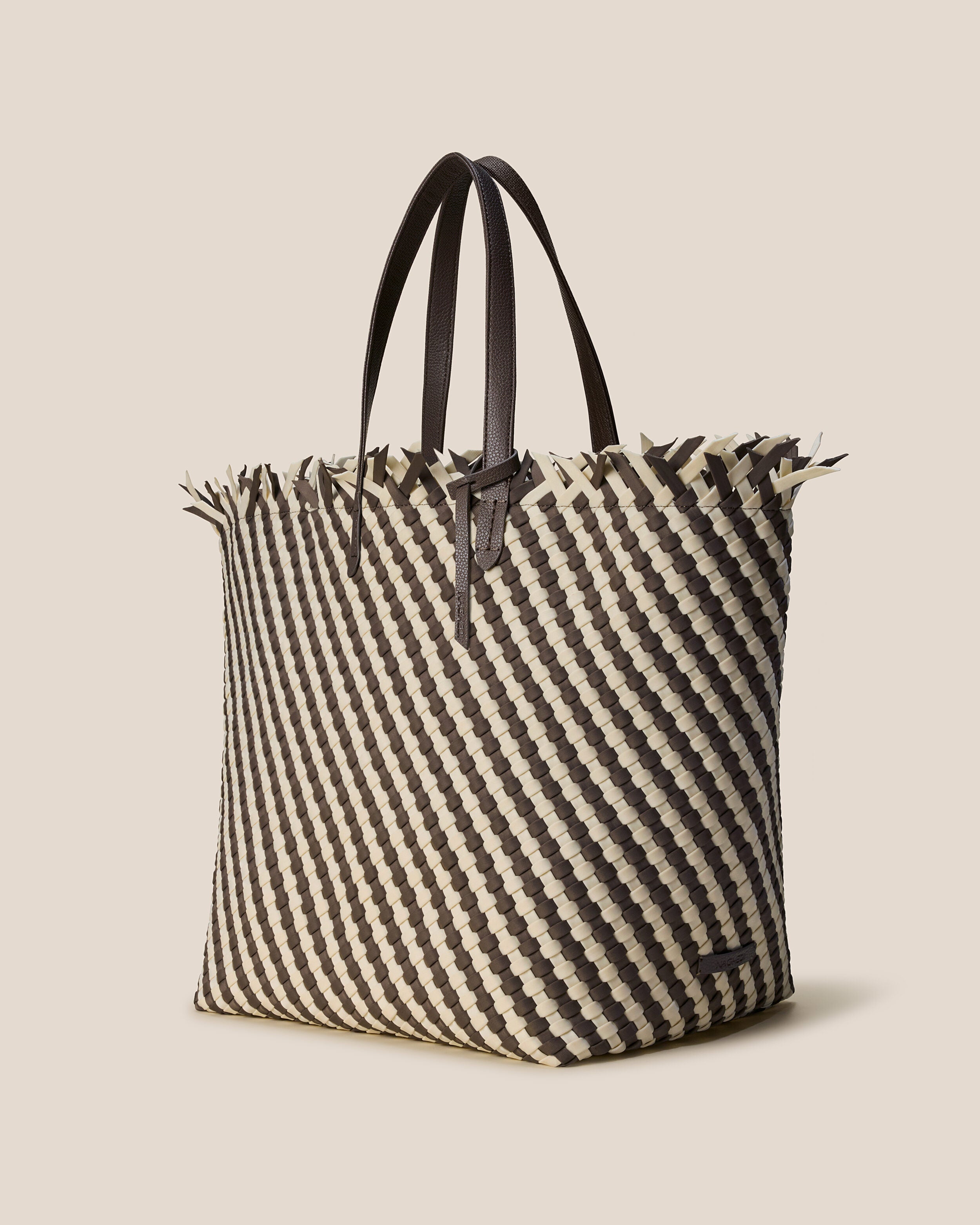 Havana  in Carrara shown from a side angle, highlighting its handwoven neoprene construction and top zip closure.