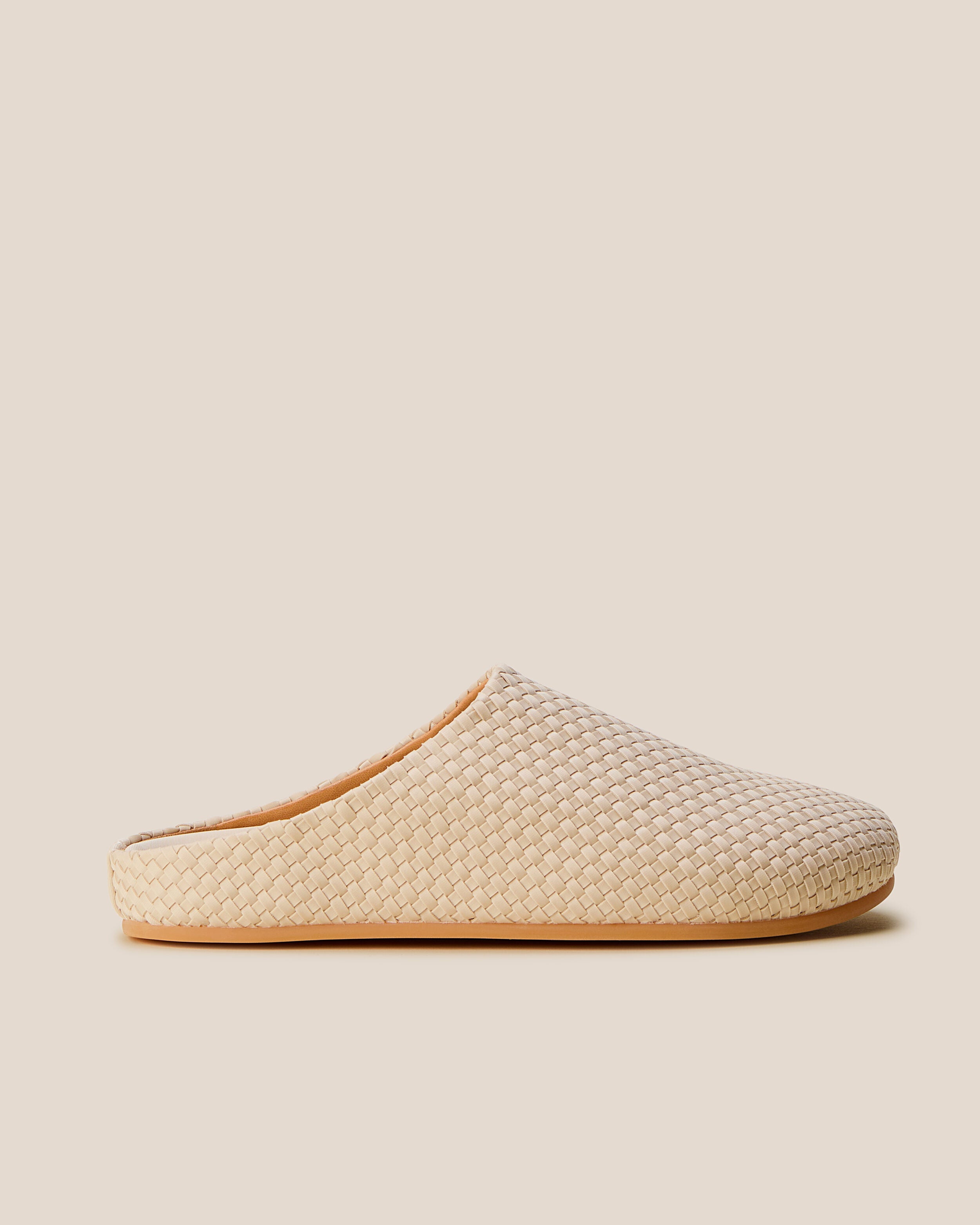Side view of The Hudson Clog in Ecru, a cream tone, featuring a closed toe and round silhouette.
