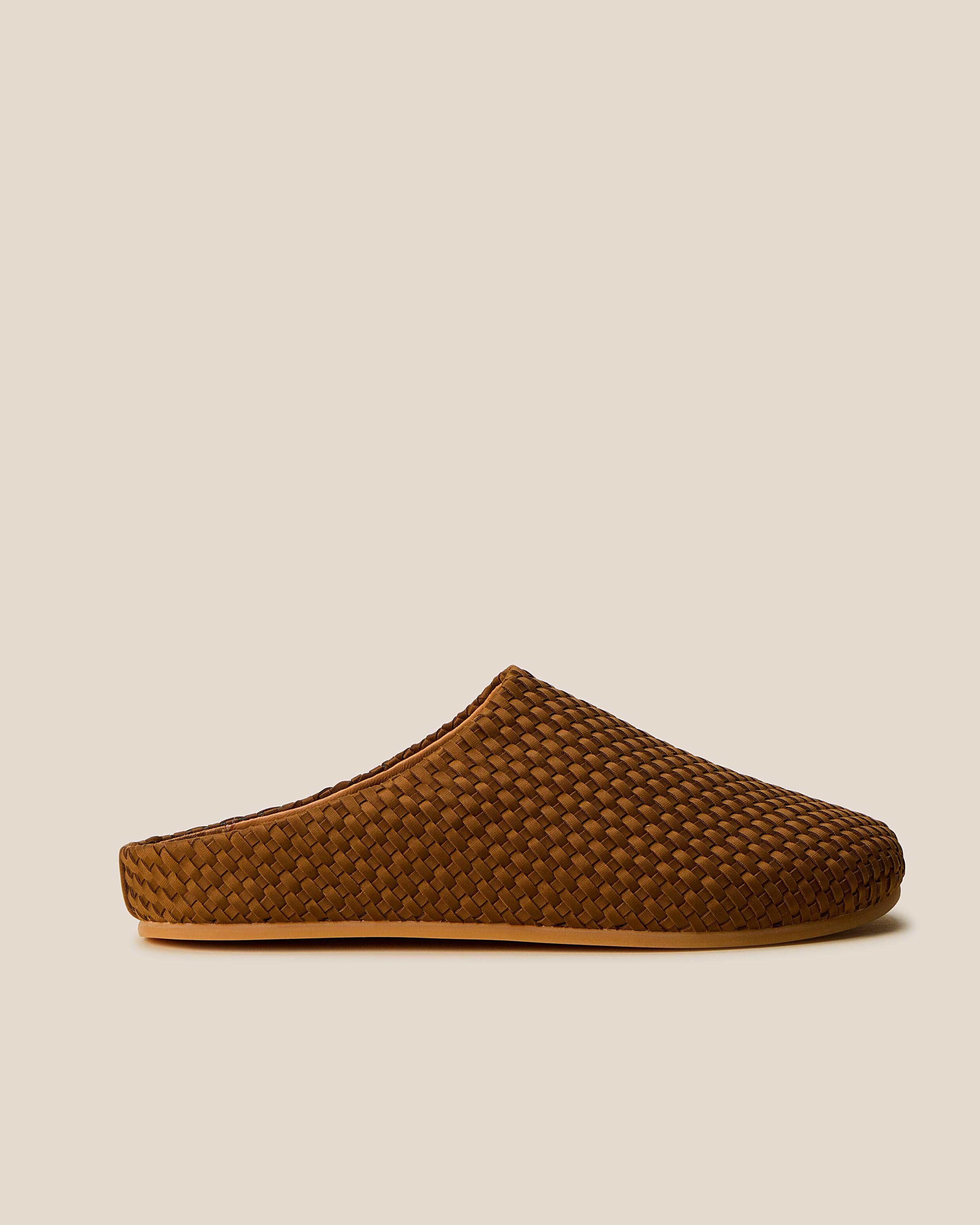 Side view of The Hudson Clog in Teak, a saddle brown tone, featuring a closed toe and round silhouette.