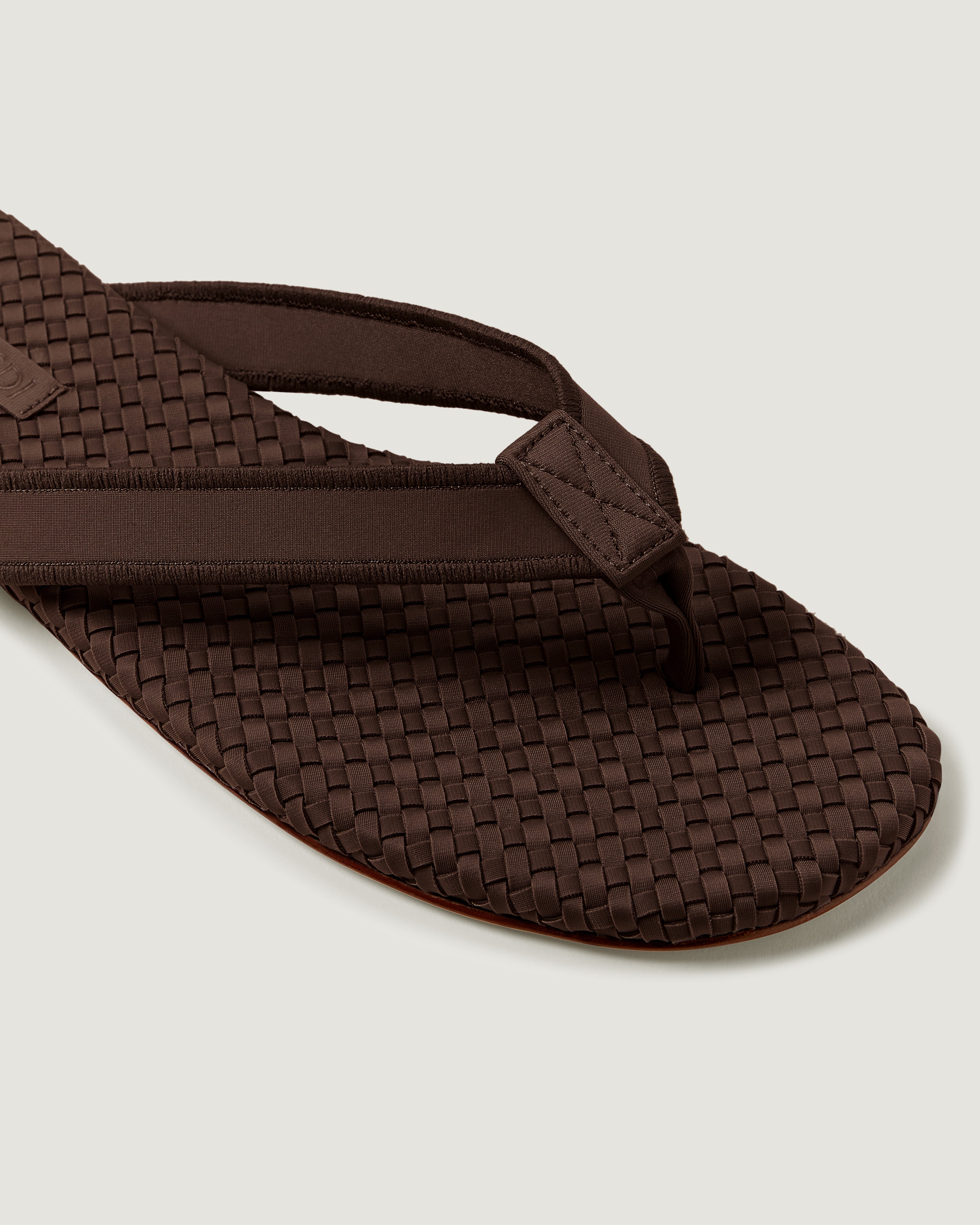 Close-up of The Hydra Flip Flop in Chocolate showing its open toe and square silhouette.