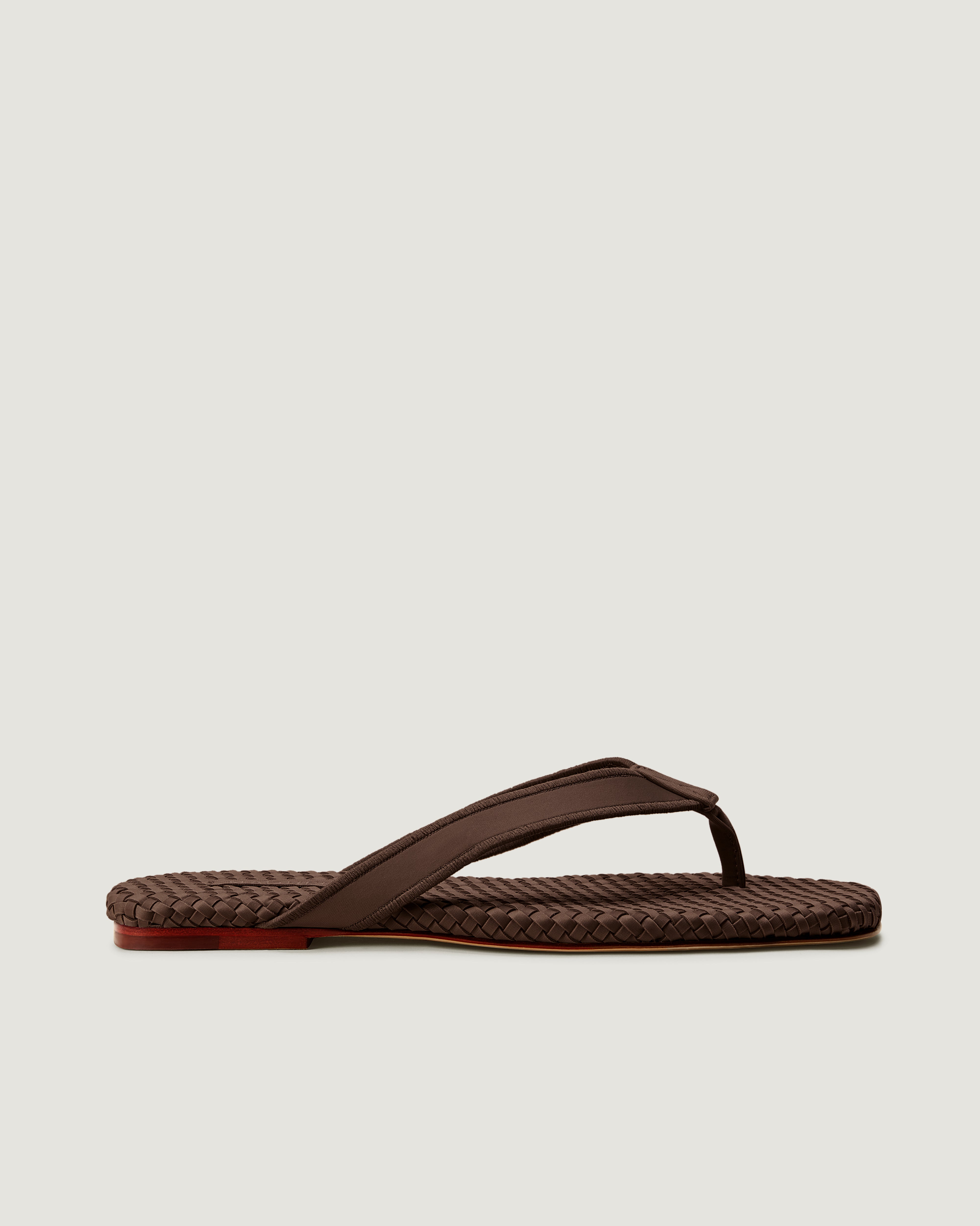 Side view of Hydra Flip Flop in Chocolate, a rich brown tone, featuring an thong toe and square silhouette.