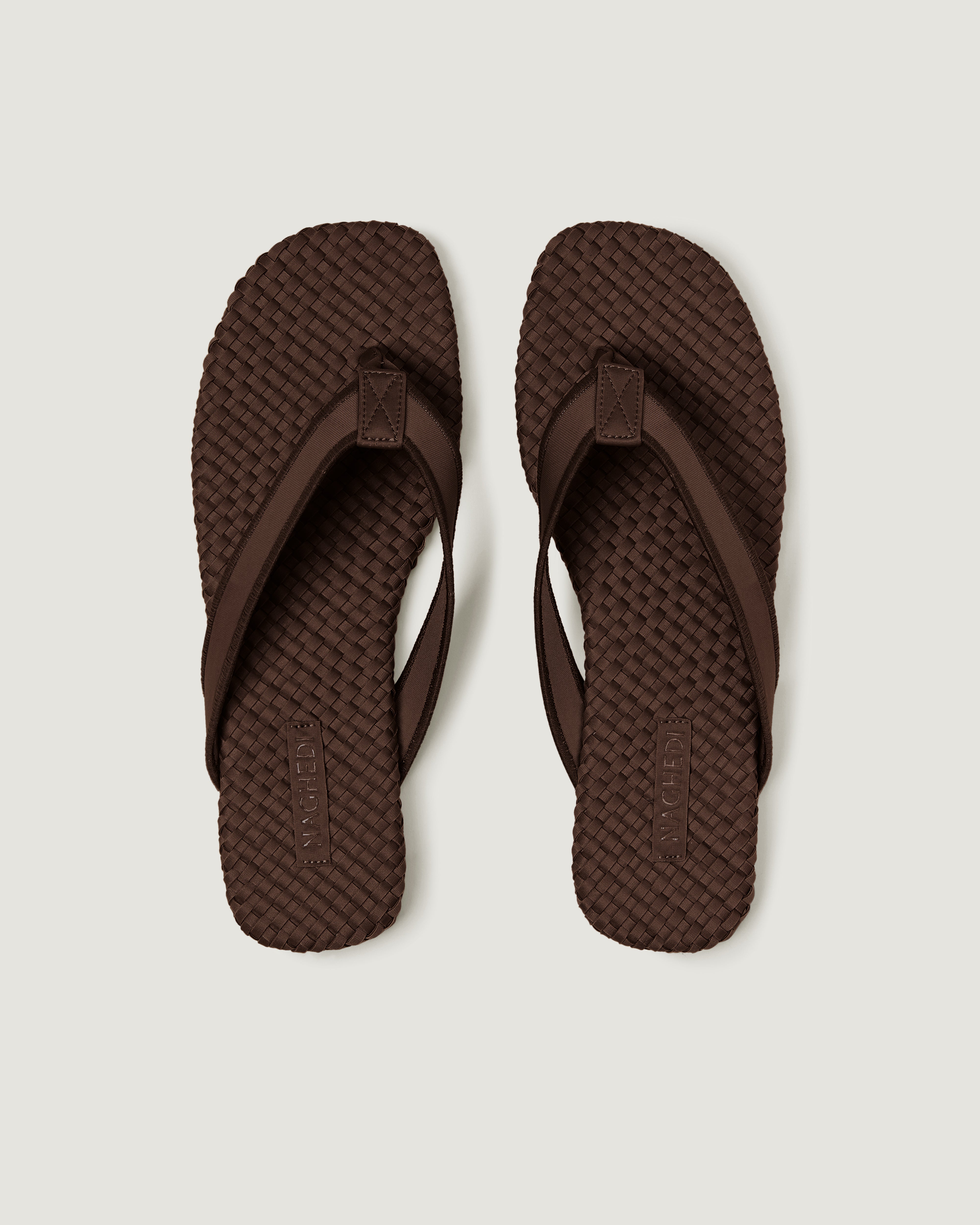 Top view of pair of The Hydra Flip Flop in Chocolate showing the handwoven neoprene insole.