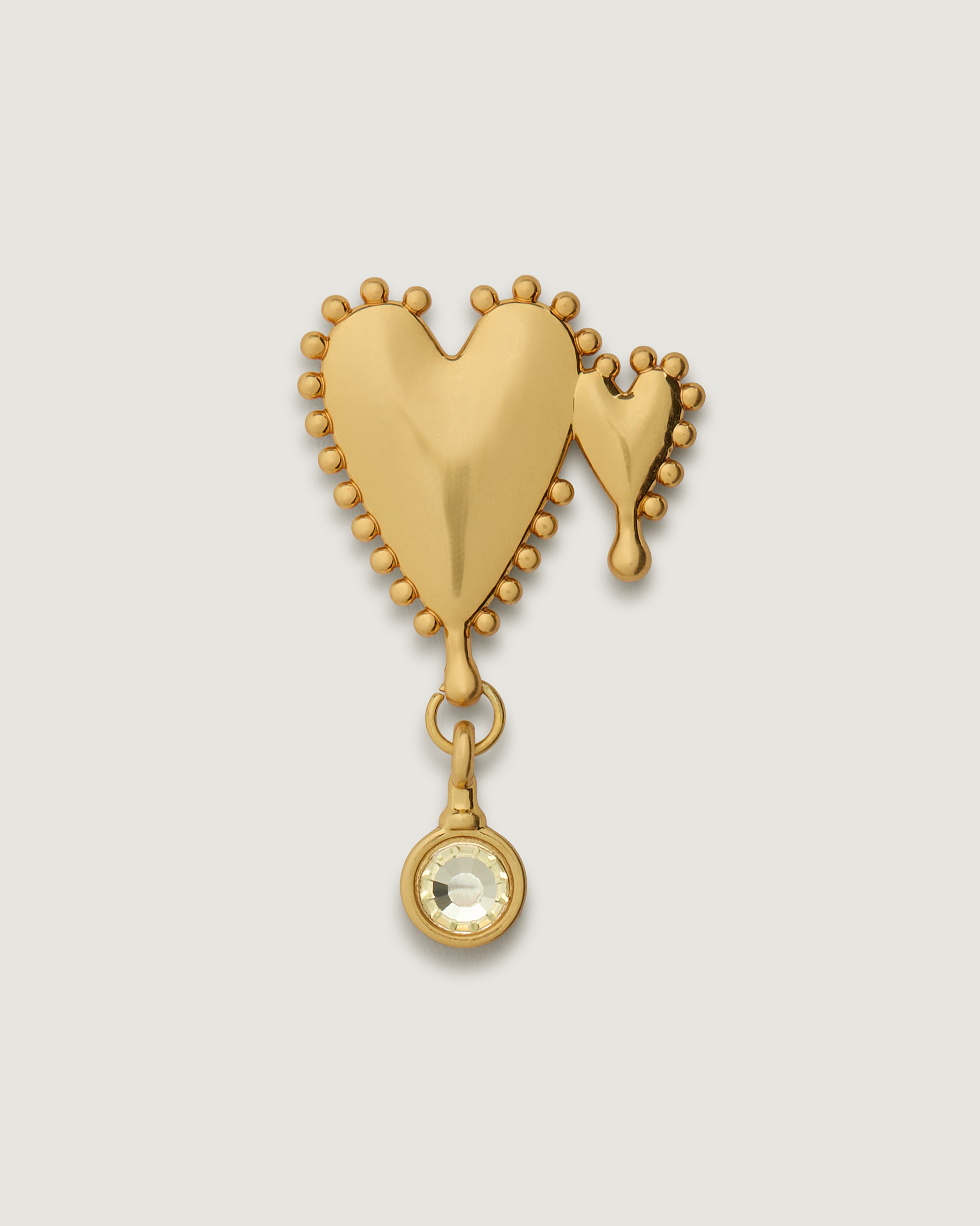 Brushed gold duel heart bag charm featuring a white gem stone.