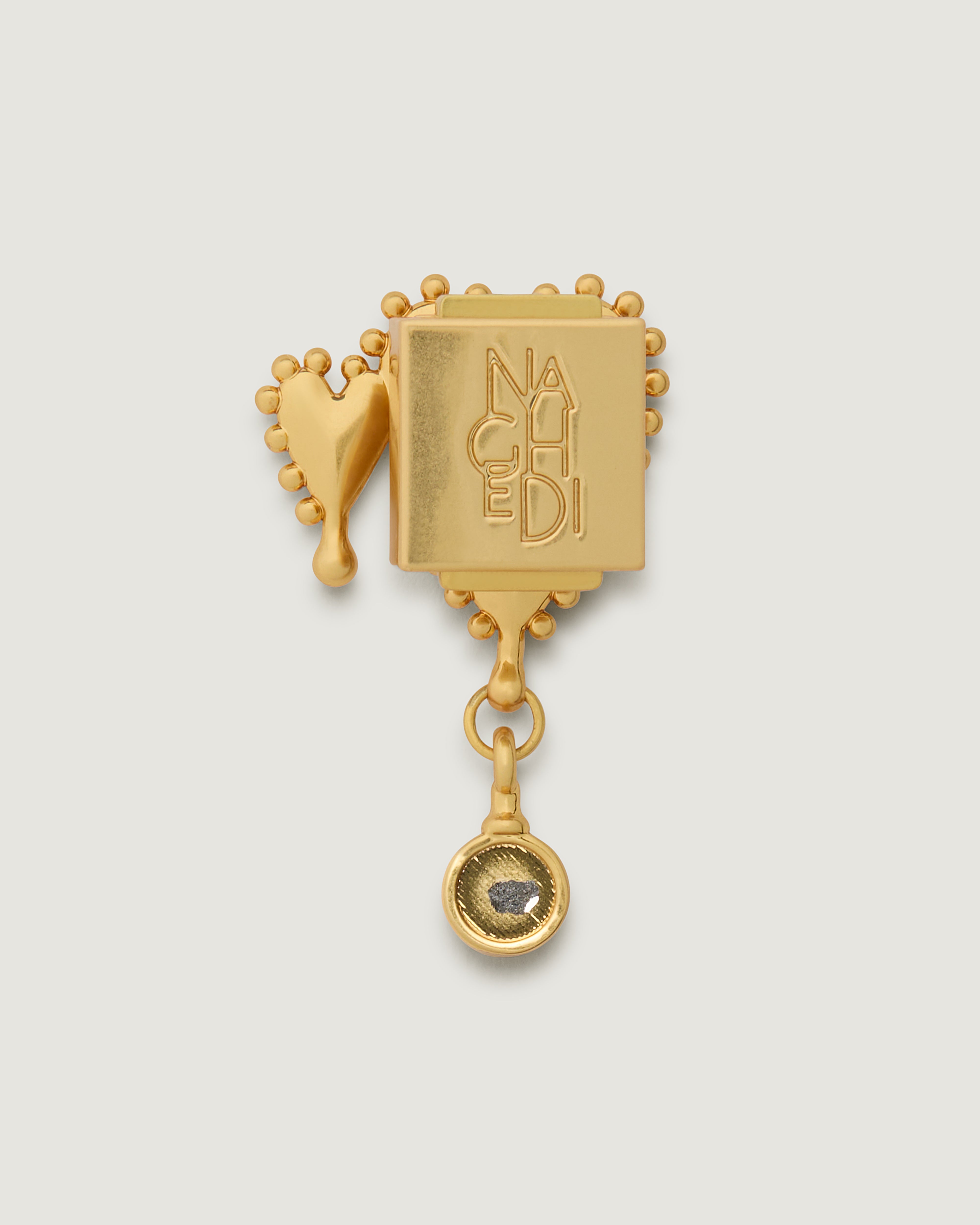 Close up of the Heart of Gold Bag Charm highlighting the pin backing.
