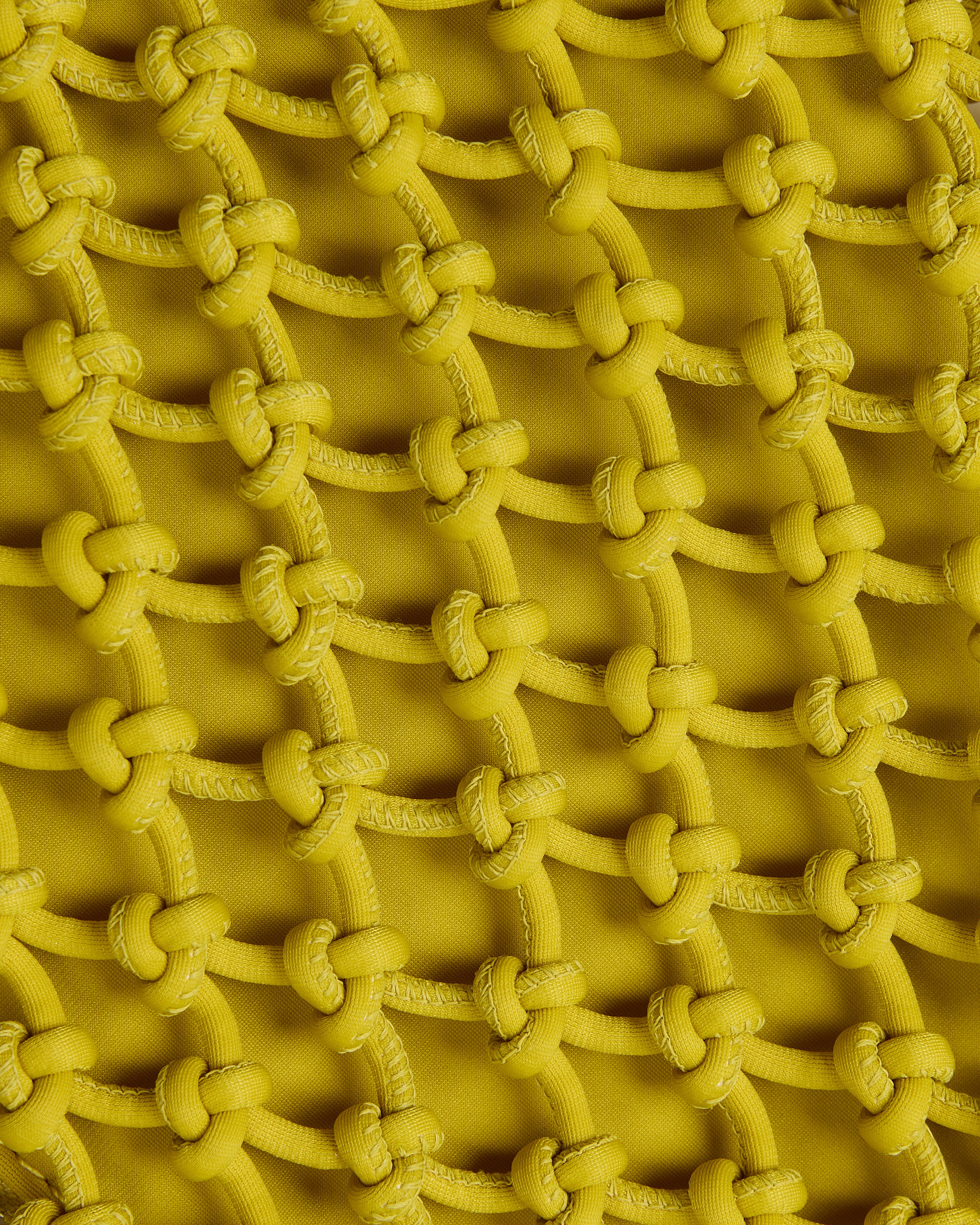 Close of up structure of woven neoprene net bag in golden chartreuse
