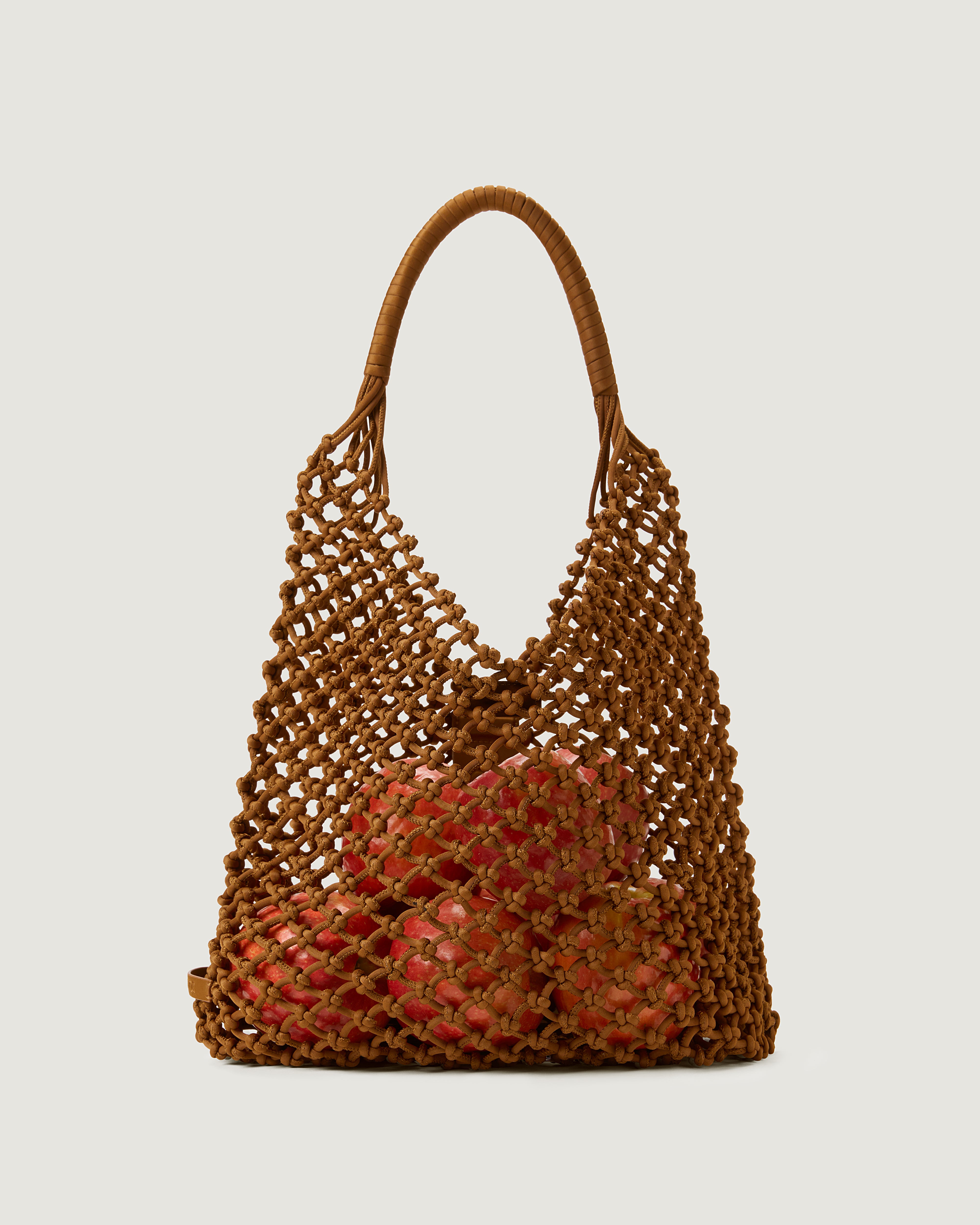 Large woven saddle brown net bag with apples inside