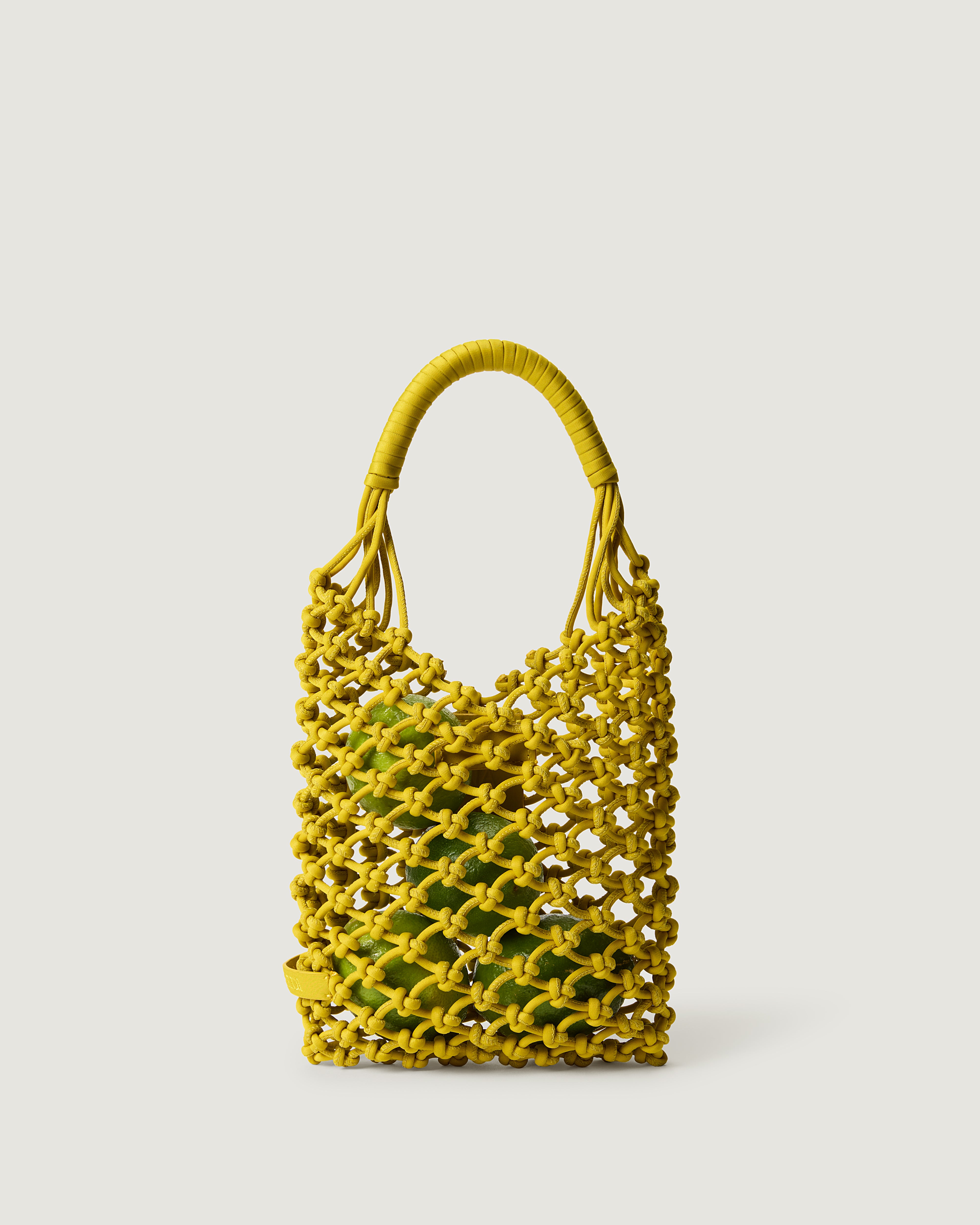 Small woven neoprene net bag in golden chartreuse with fruit inside