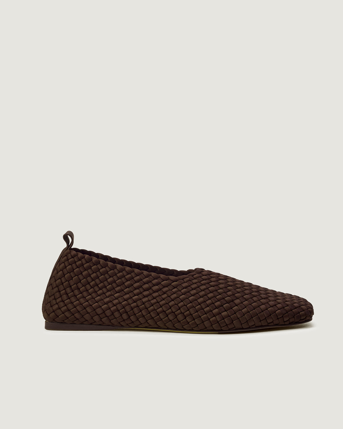 Side view of Jeju Glove Flat in Chocolate, a chocolate brown tone, featuring a closed toe and round silhouette, featuring an adjustable strap with buckle closure.