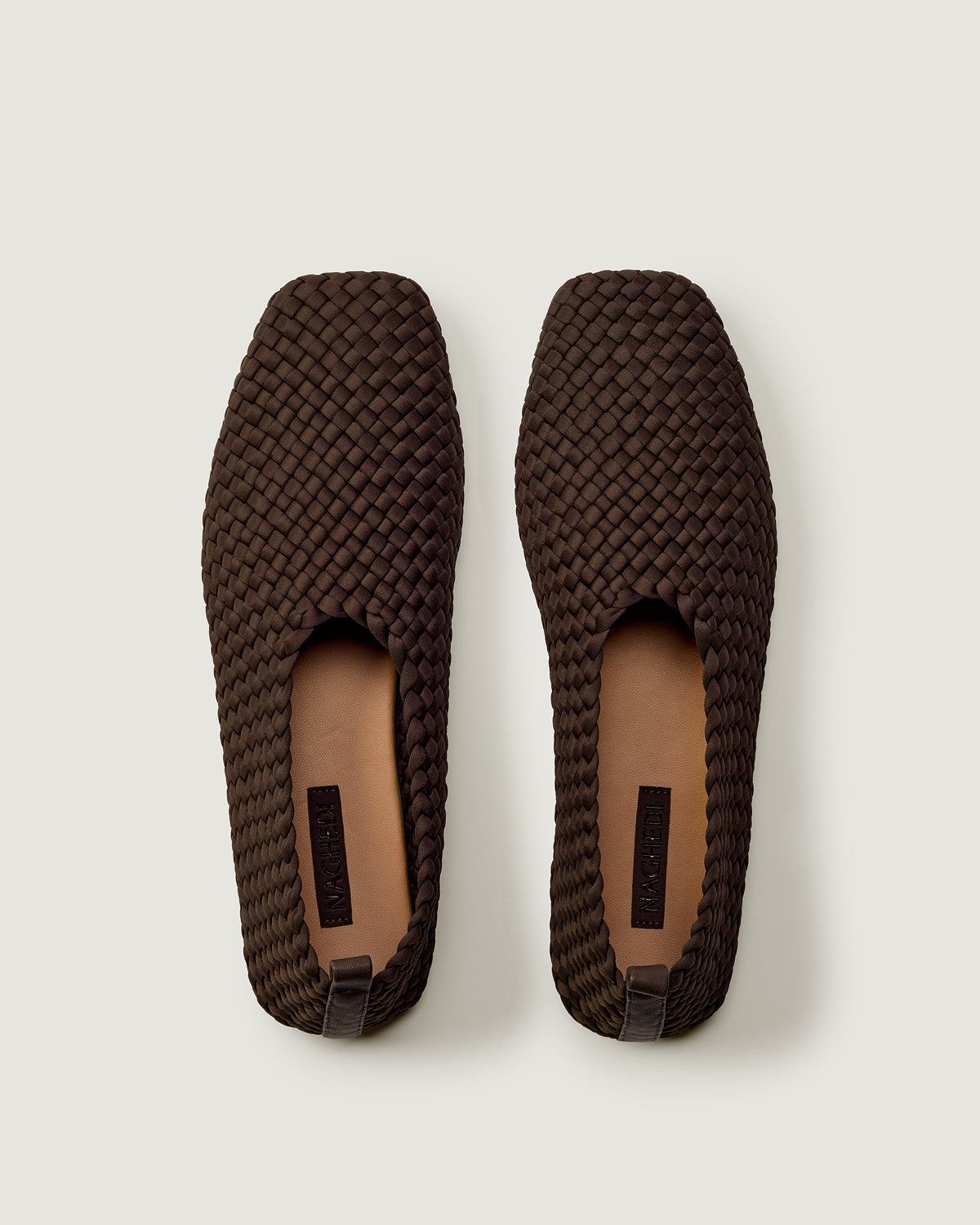 Top view of pair of The Jeju Glove Flat in Chocolate showing the natural tanned leather insole