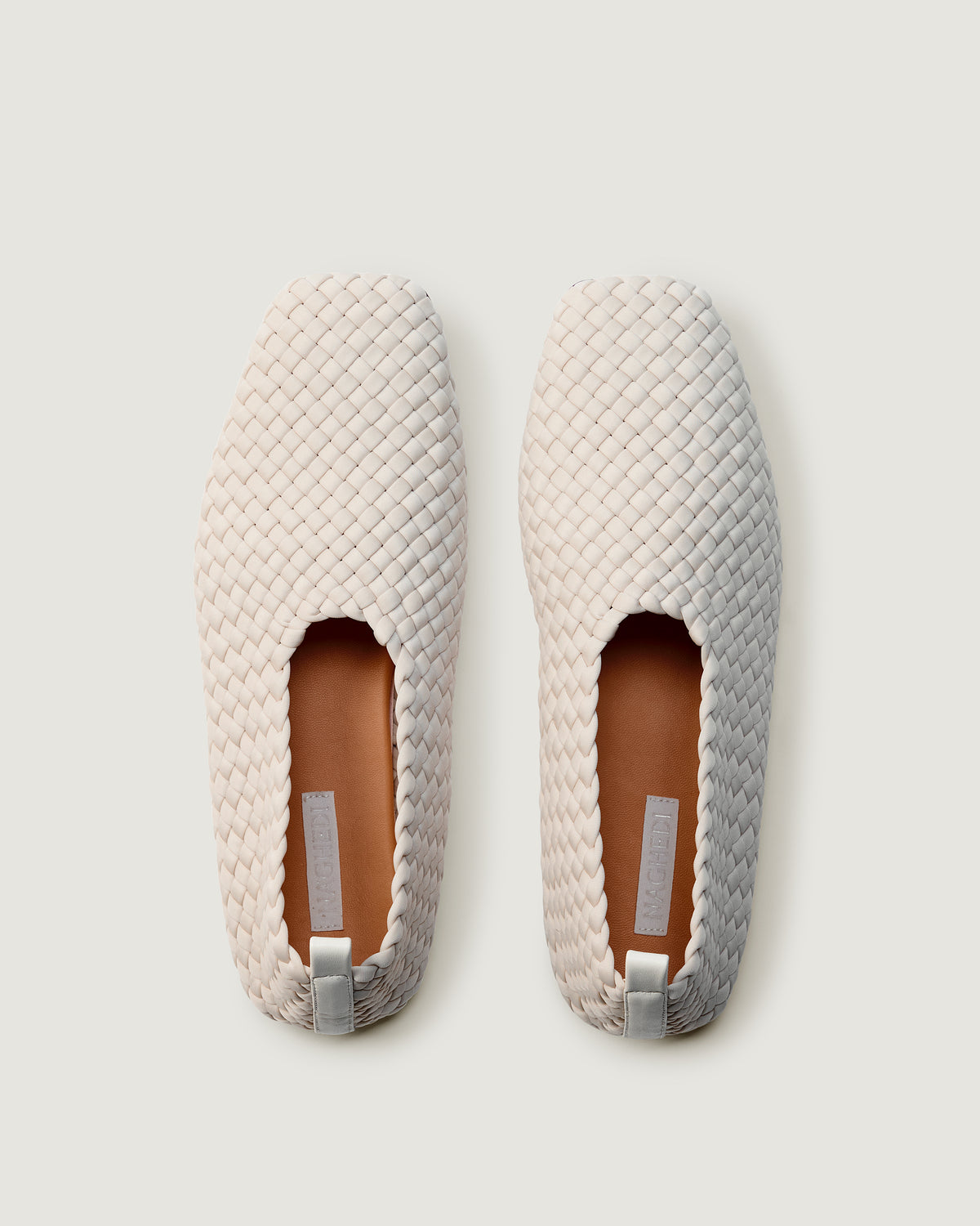 Top view of pair of The Jeju Glove Flat in Linen showing the natural tanned leather insole