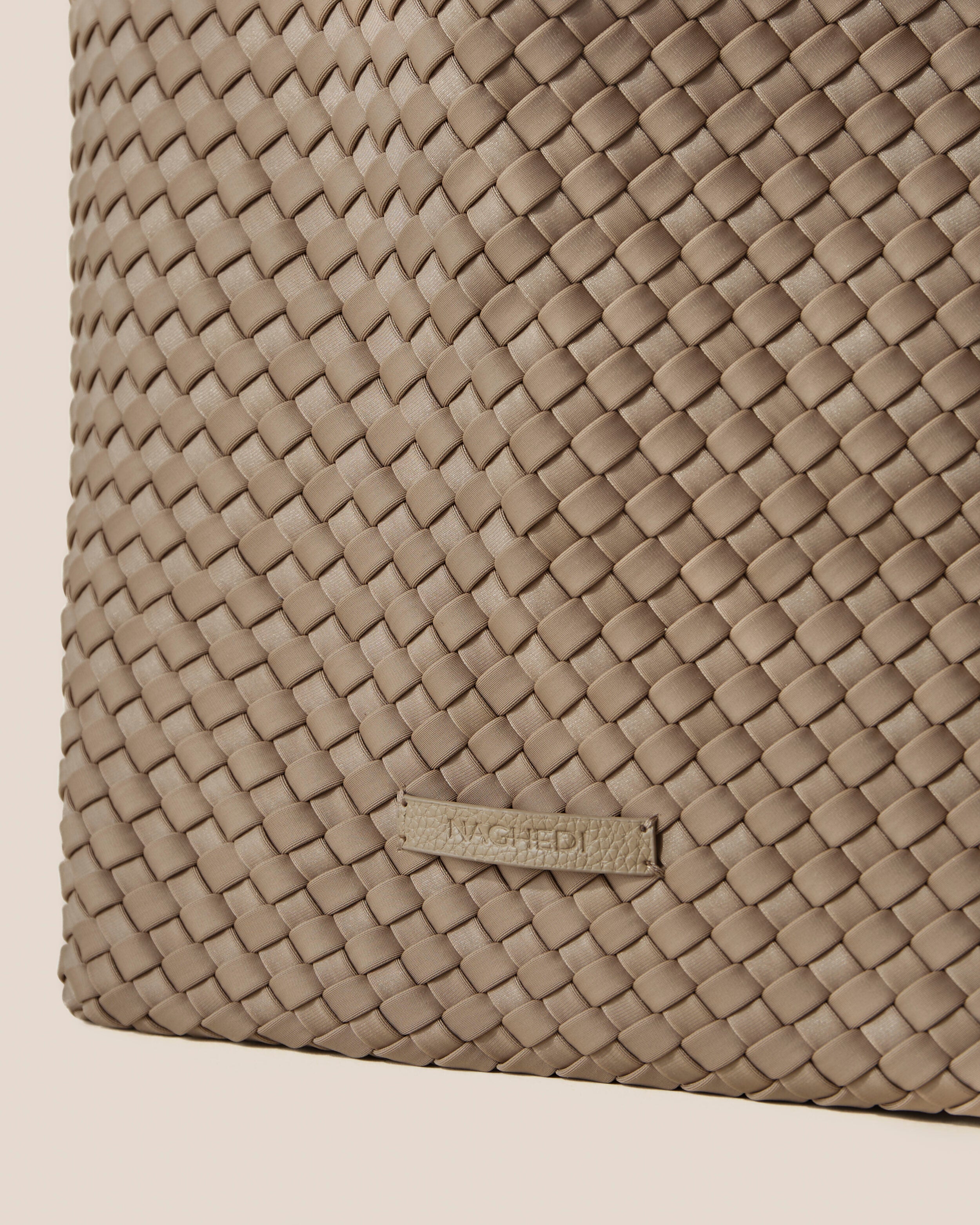 Close-up of stamped NAGHEDI logo on Jetsetter Tote in Cashmere.