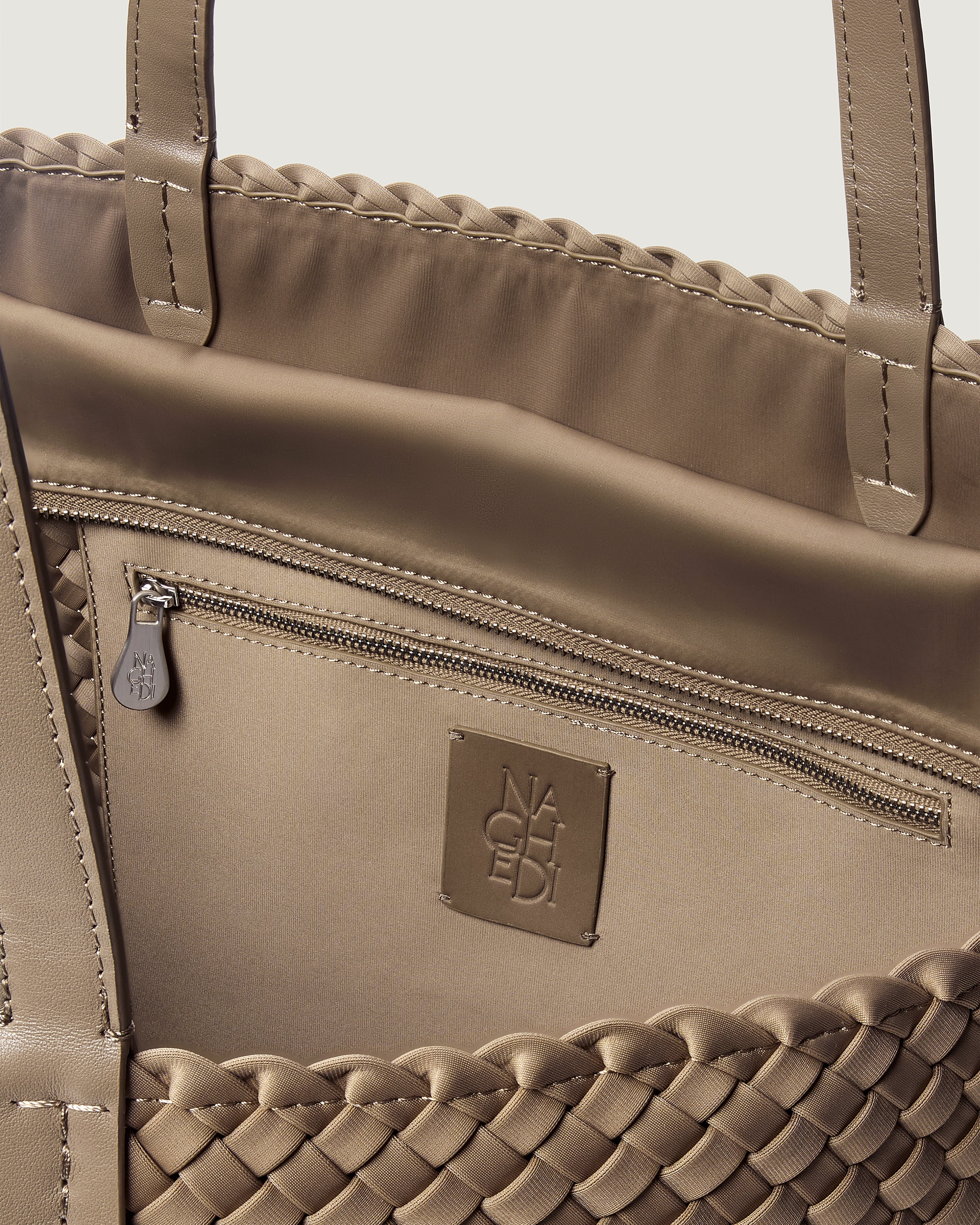 Interior close-up of Jetsetter Tote in Cashmere showing its top zip closure, interior pocket, and unlined interior.