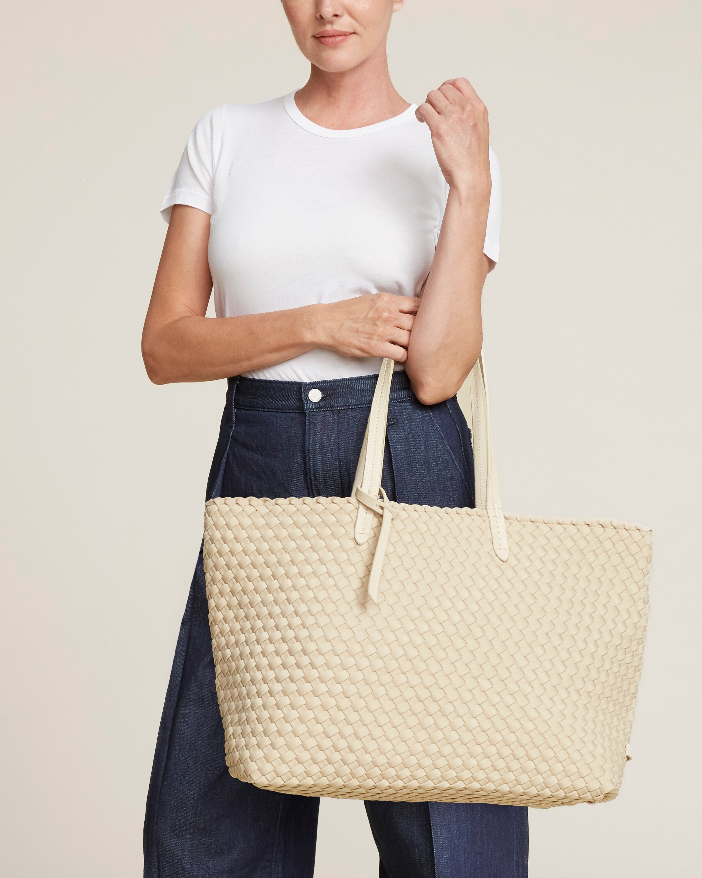 Jetsetter Tote in Ecru shown on model to illustrate scale and soft silhouette.