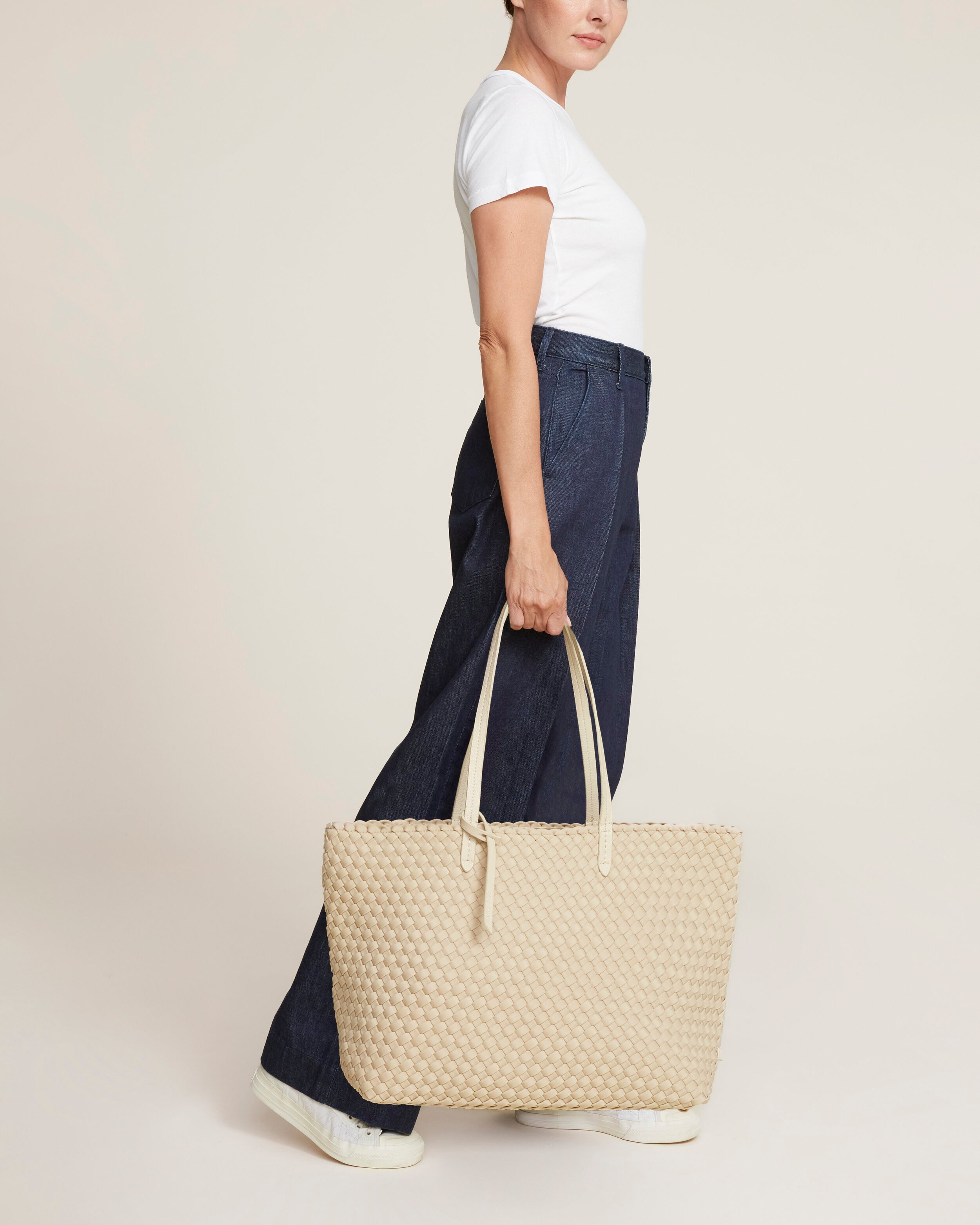 Jetsetter Tote in Ecru shown on model to illustrate scale and soft silhouette.