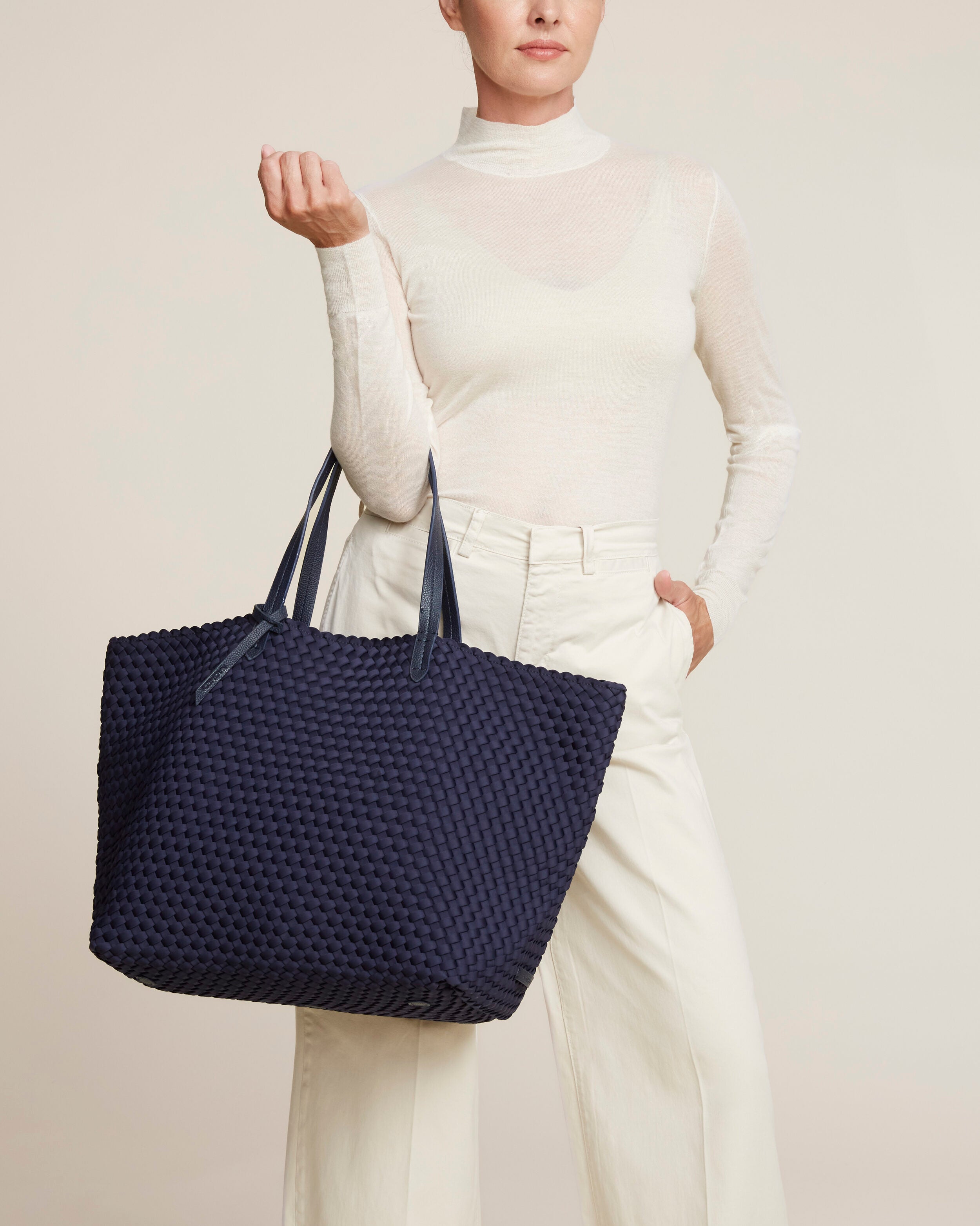 Jetsetter Tote in Ink Blue shown on model to illustrate scale and soft silhouette.