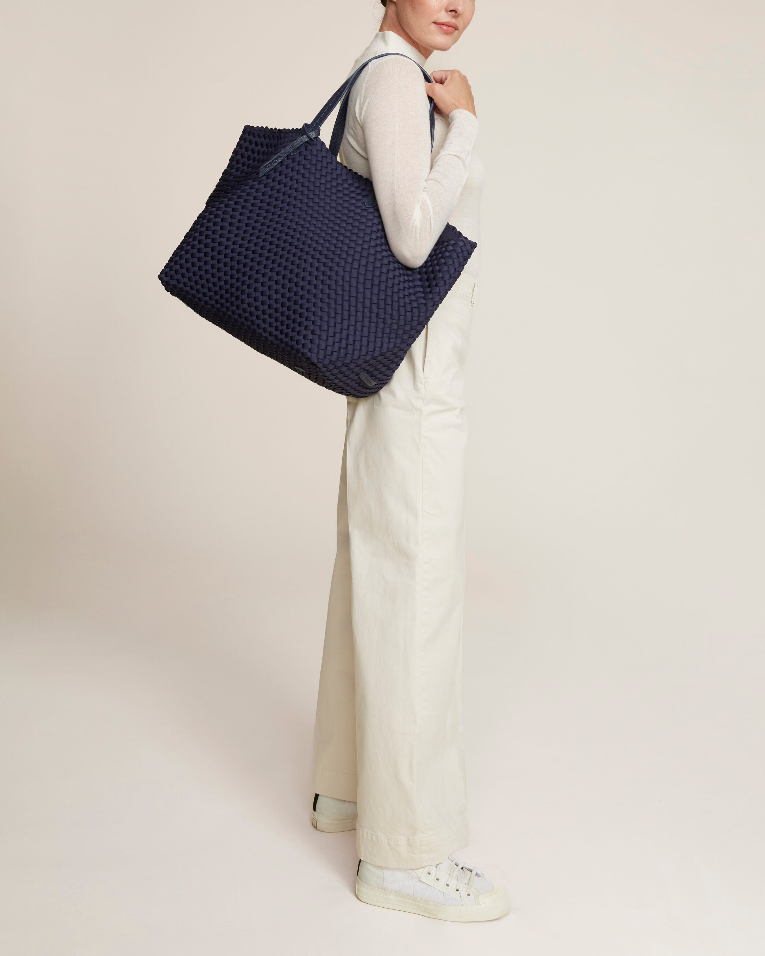 Jetsetter Tote in Ink Blue shown on model to illustrate scale and soft silhouette.