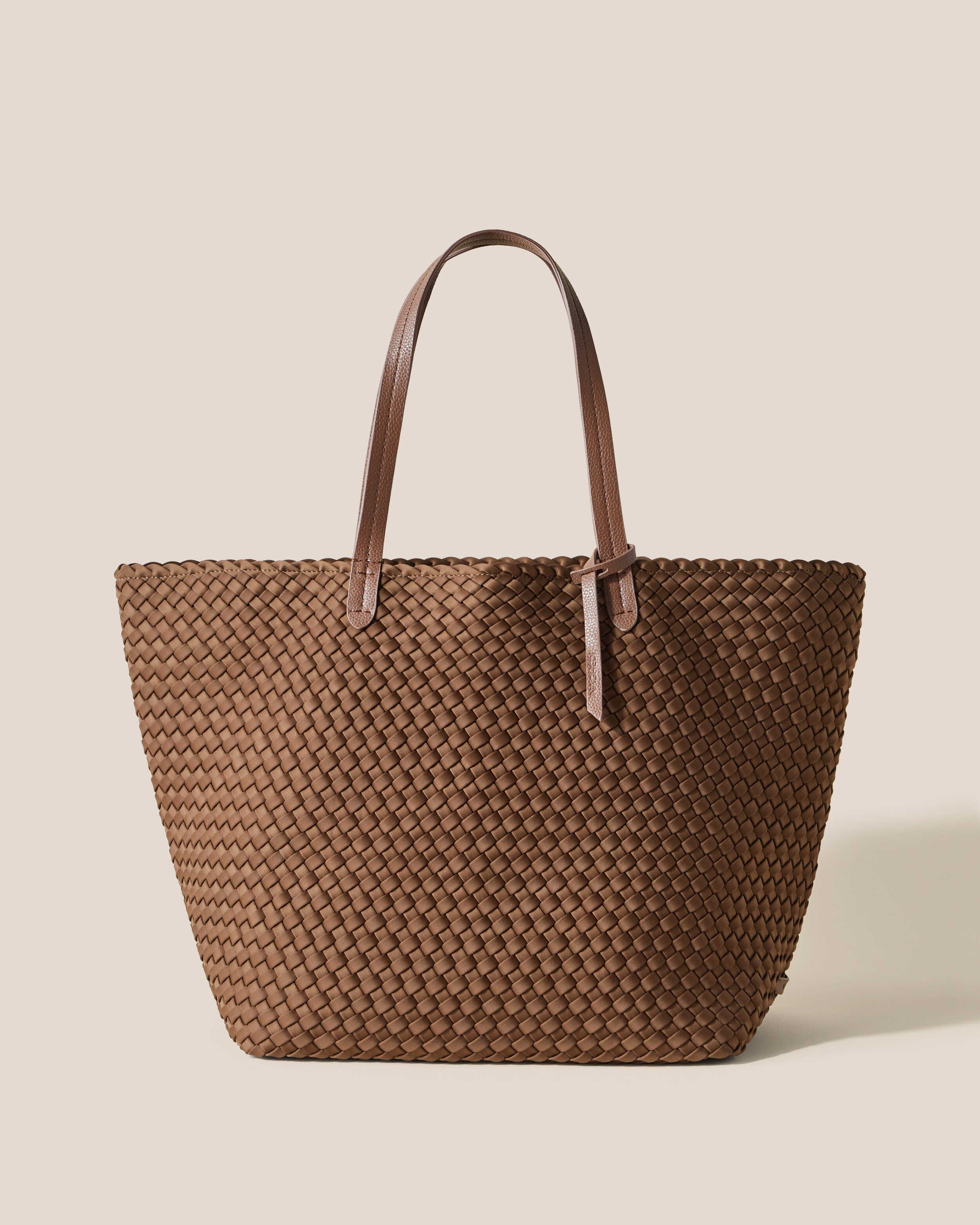 Jetsetter Tote in Mink, a brown tone, in handwoven neoprene, featuring a top zip closure, and vegan leather handles.