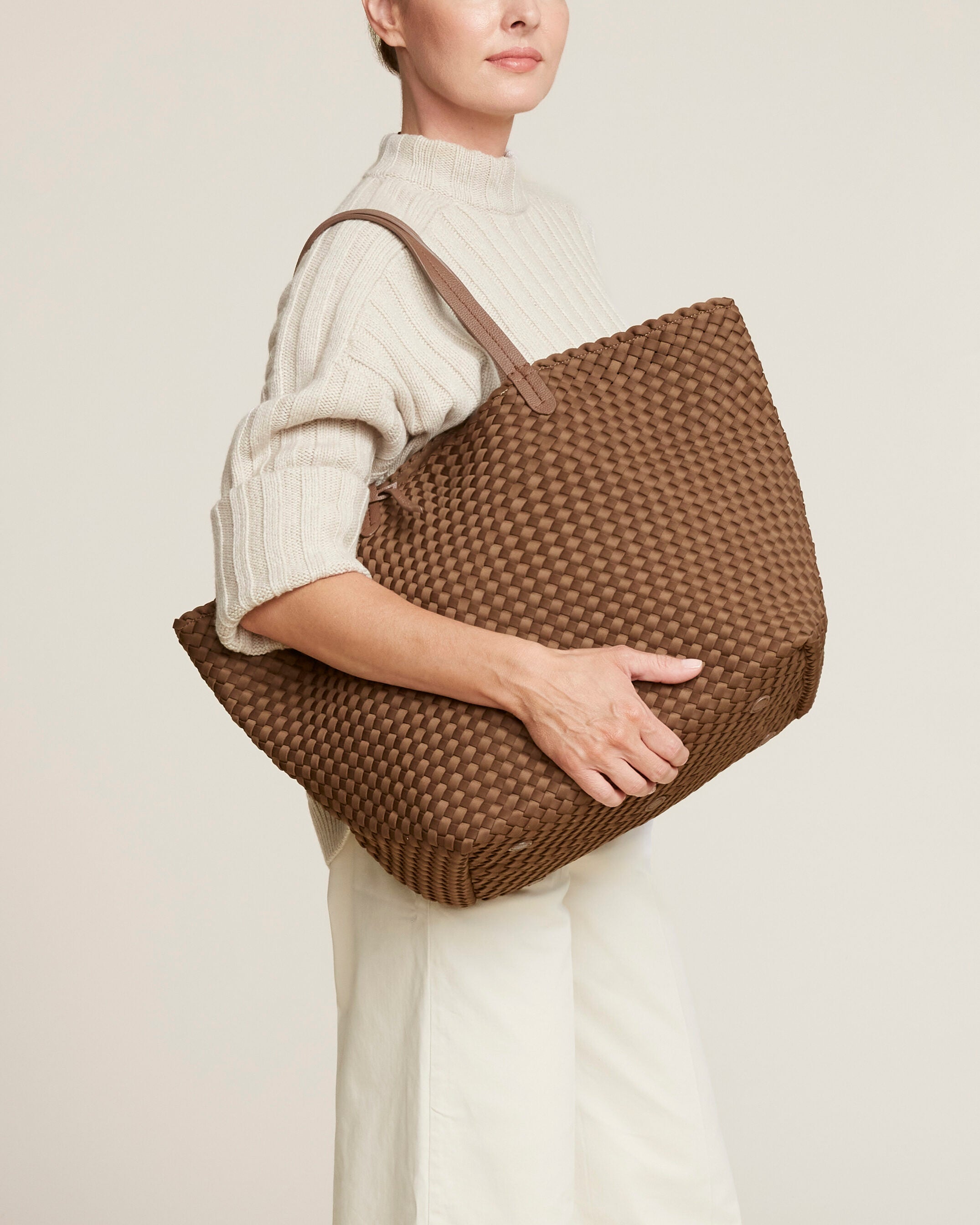 Jetsetter Tote in Mink shown on model to illustrate scale and soft silhouette.