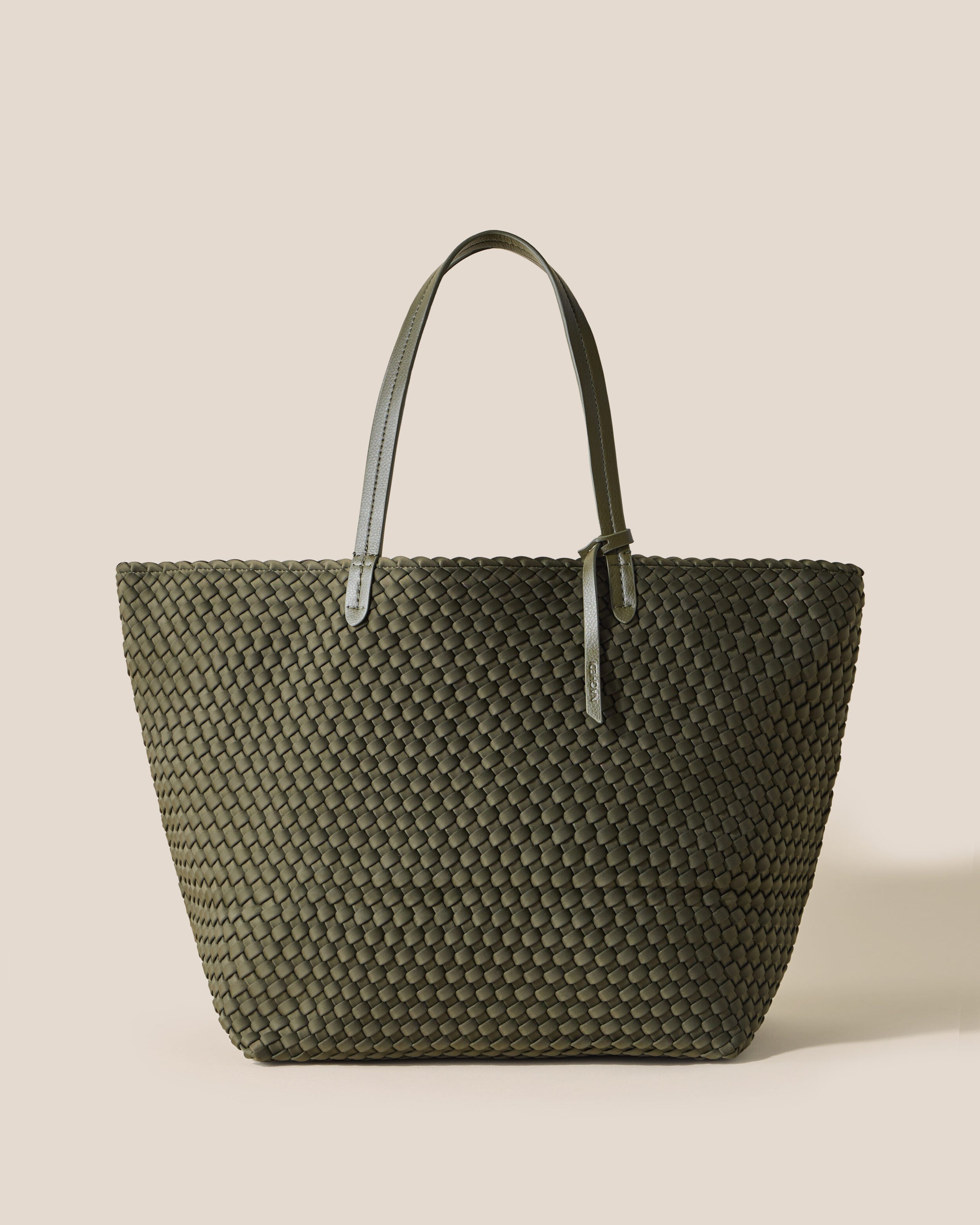 Jetsetter Tote in Olive, an olive green tone, in handwoven neoprene, featuring a top zip closure, and vegan leather handles.