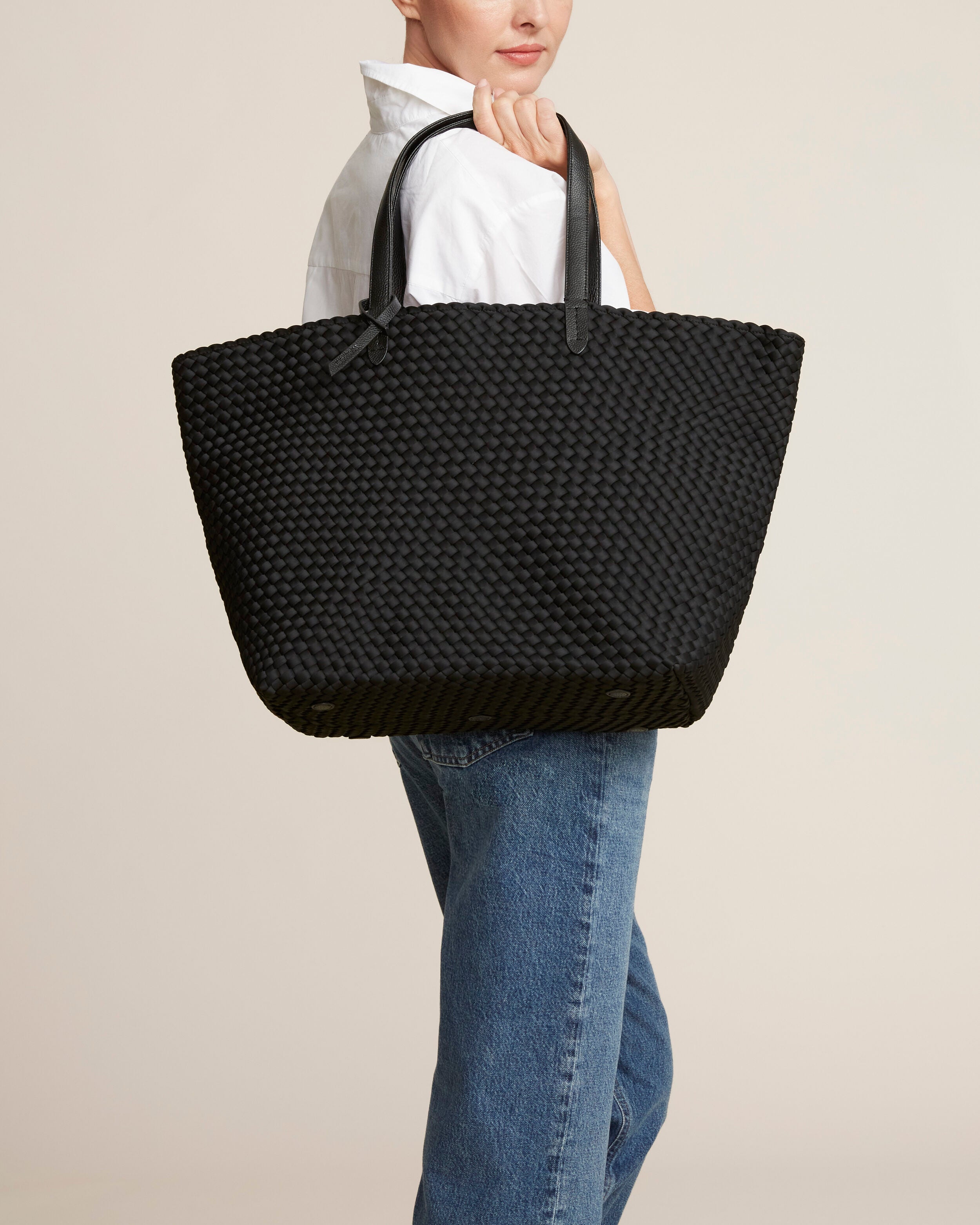 Jetsetter Tote in Onyx shown on model to illustrate scale and soft silhouette.