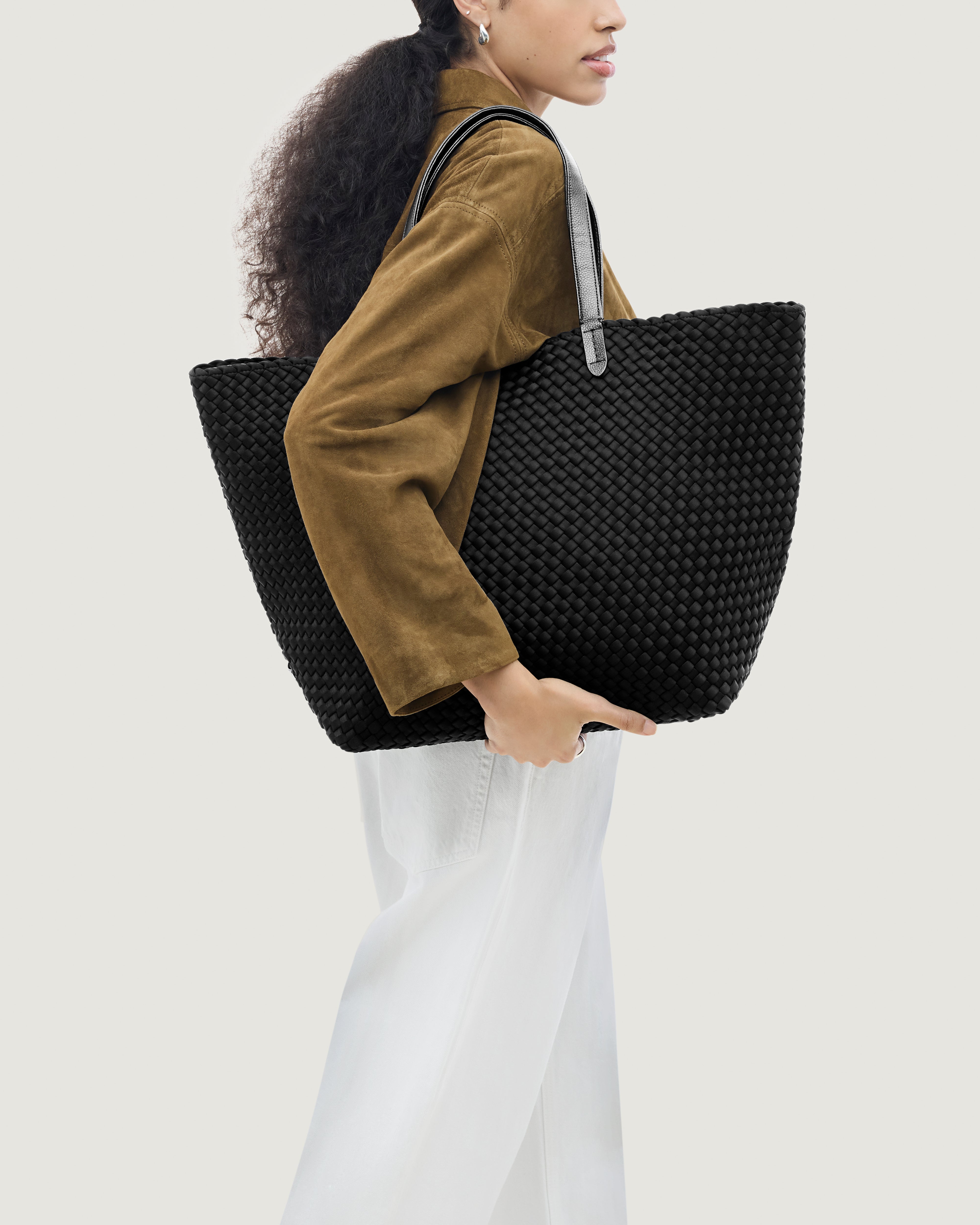Jetsetter Tote in Onyx shown on model to illustrate scale and soft silhouette.