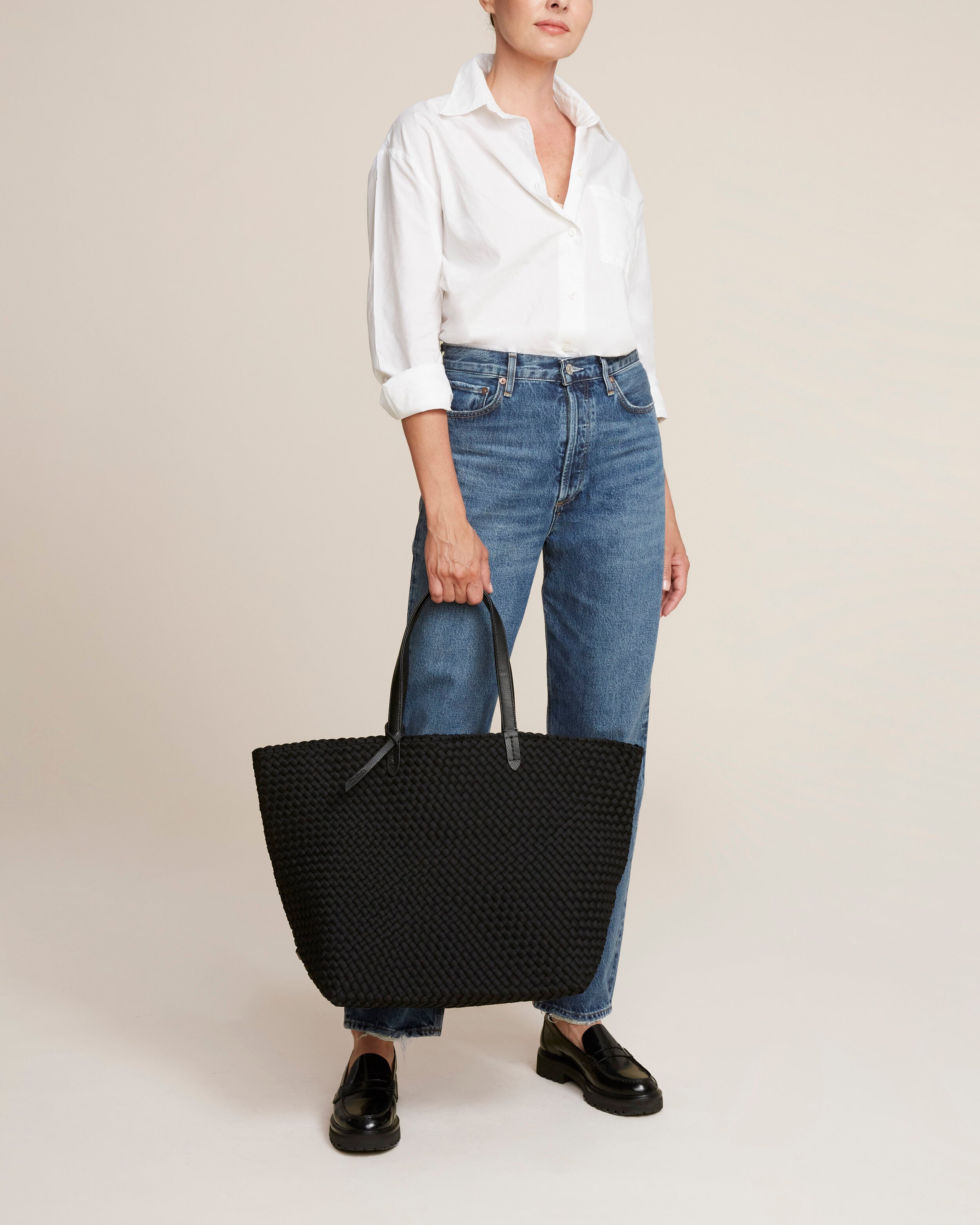 Jetsetter Tote in Onyx shown on model to illustrate scale and soft silhouette.