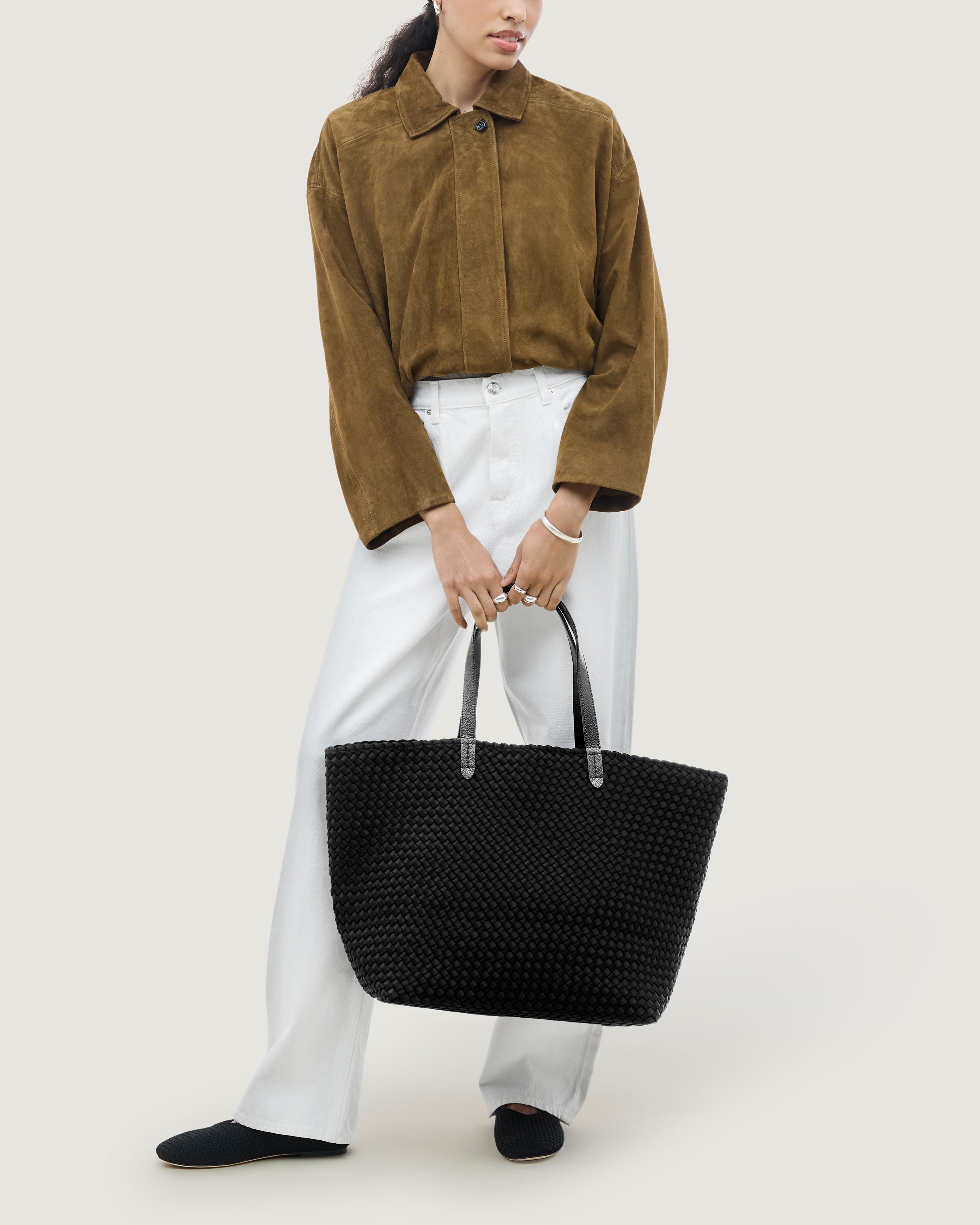 Jetsetter Tote in Onyx shown on model to illustrate scale and soft silhouette.