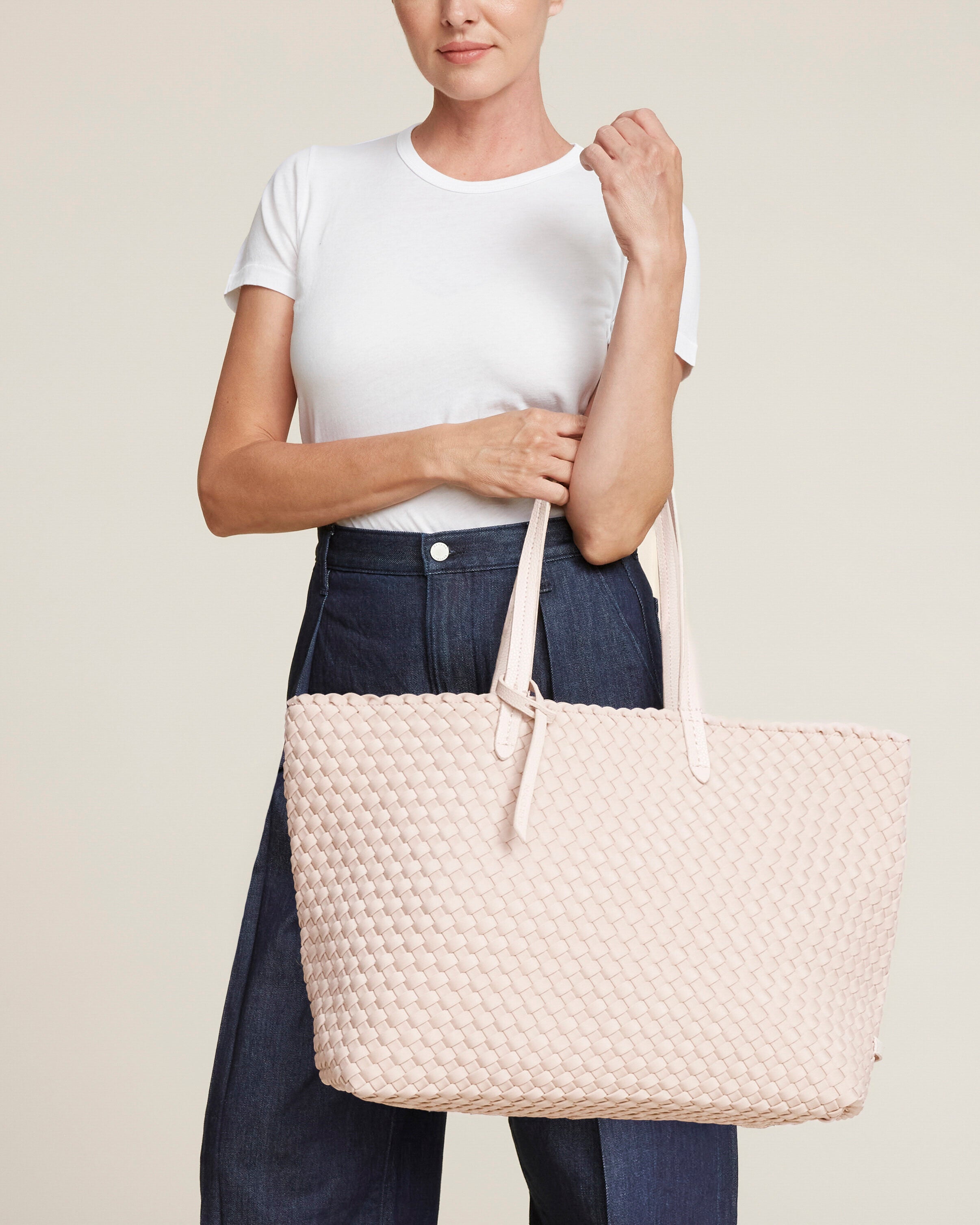 Jetsetter Tote in Shell Pink shown on model to illustrate scale and soft silhouette.